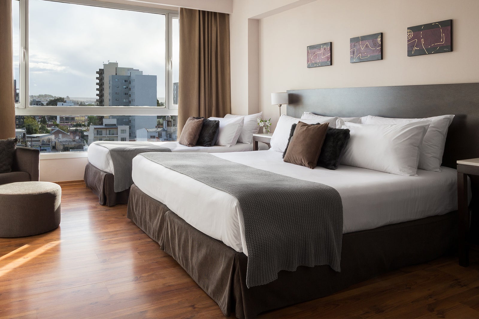 Modern 2-bed hotel room with a view of the city.