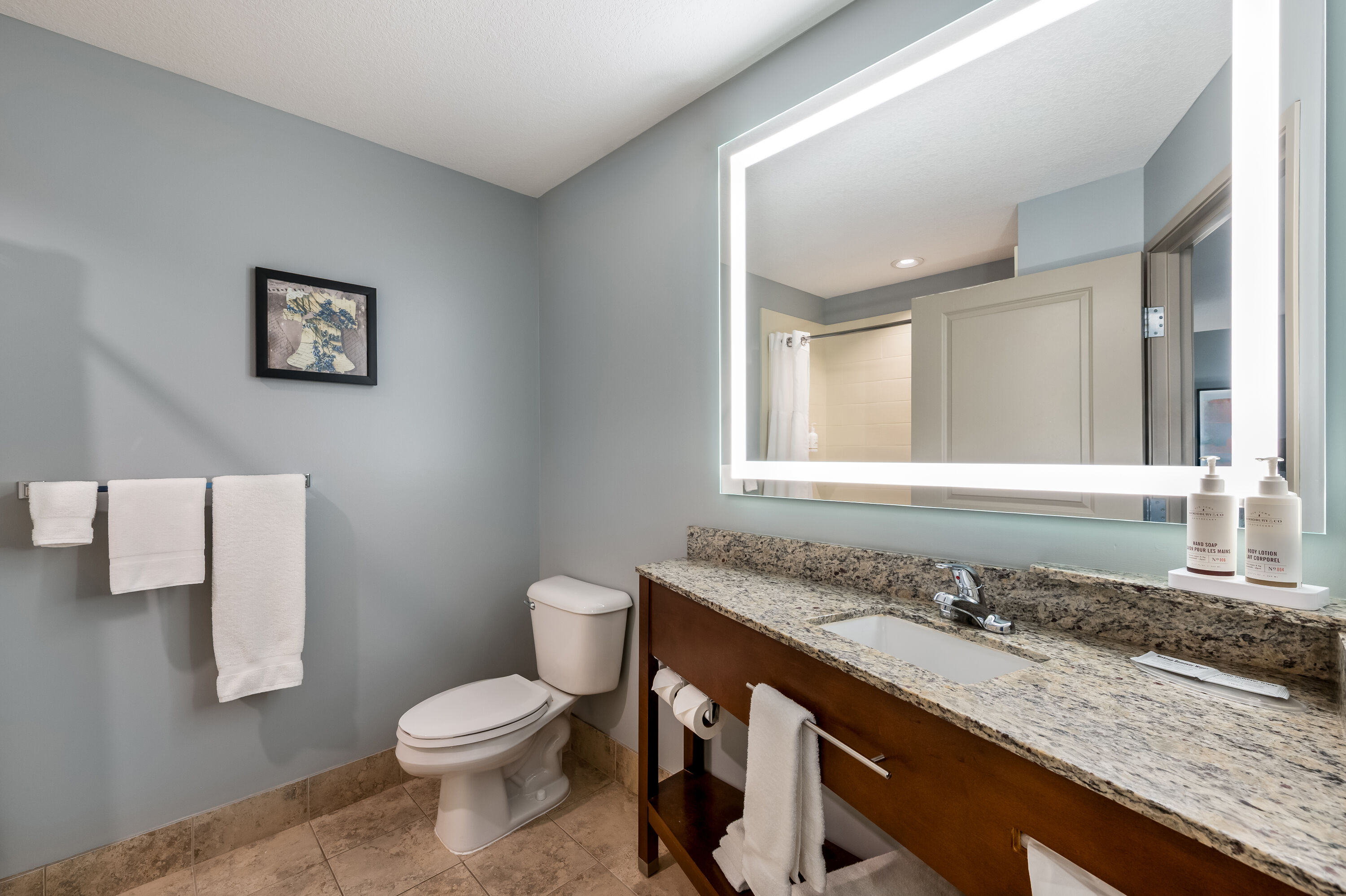 Guest room bath at the AmericInn by Wyndham Fairfield in Fairfield, Iowa