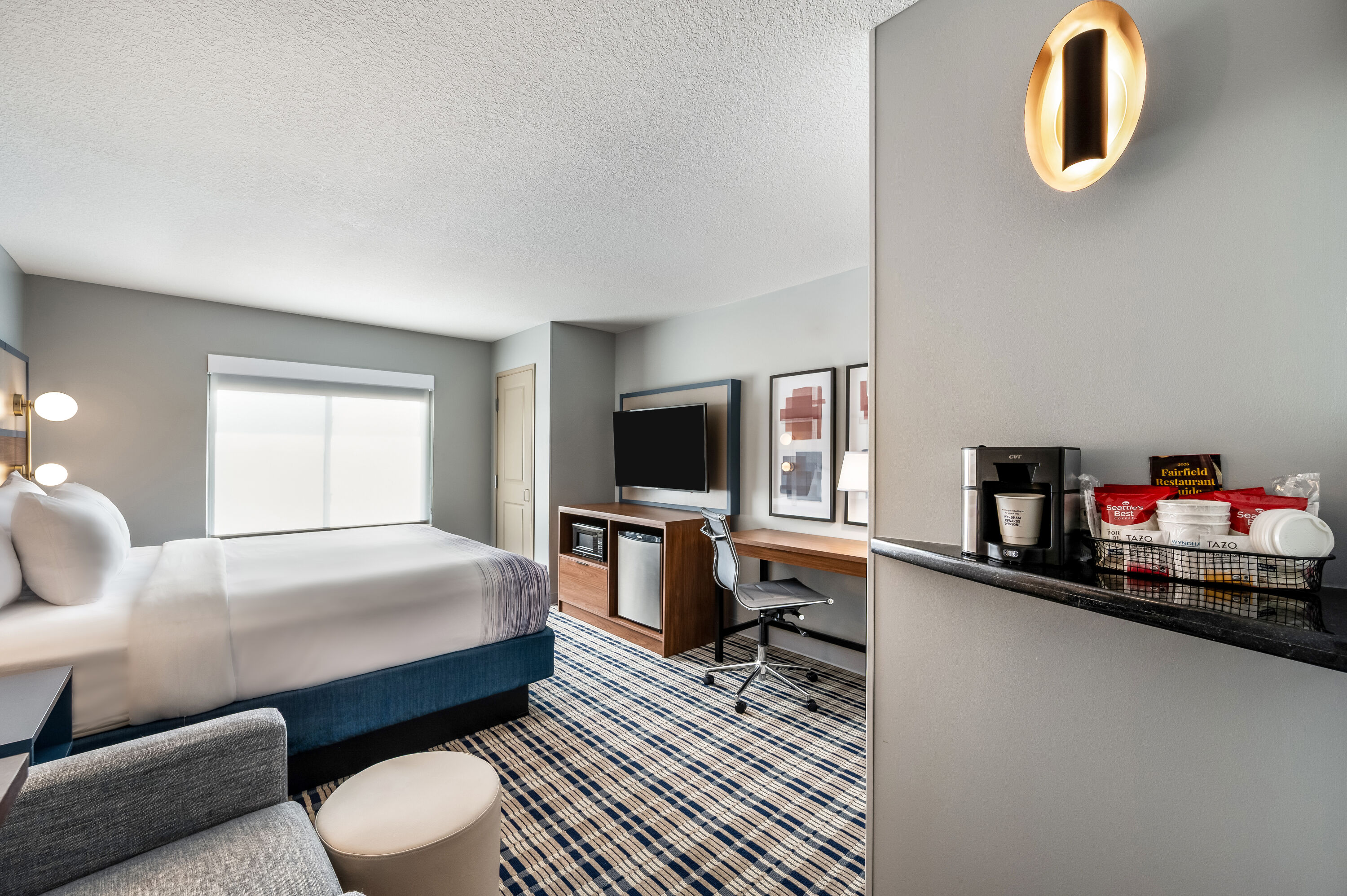 King bed guest room at the AmericInn by Wyndham Fairfield in Fairfield, Iowa