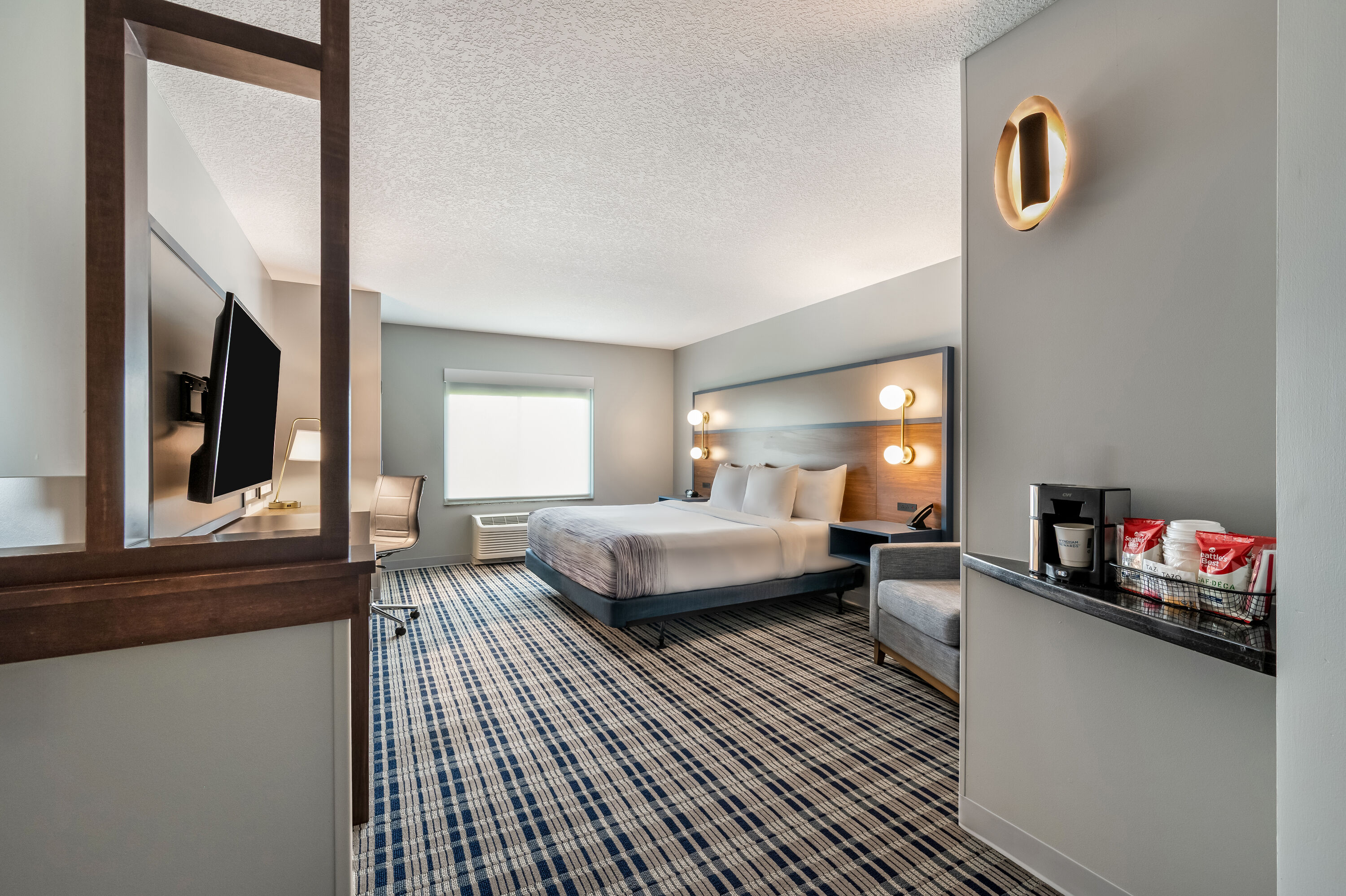 King bed guest room at the AmericInn by Wyndham Fairfield in Fairfield, Iowa