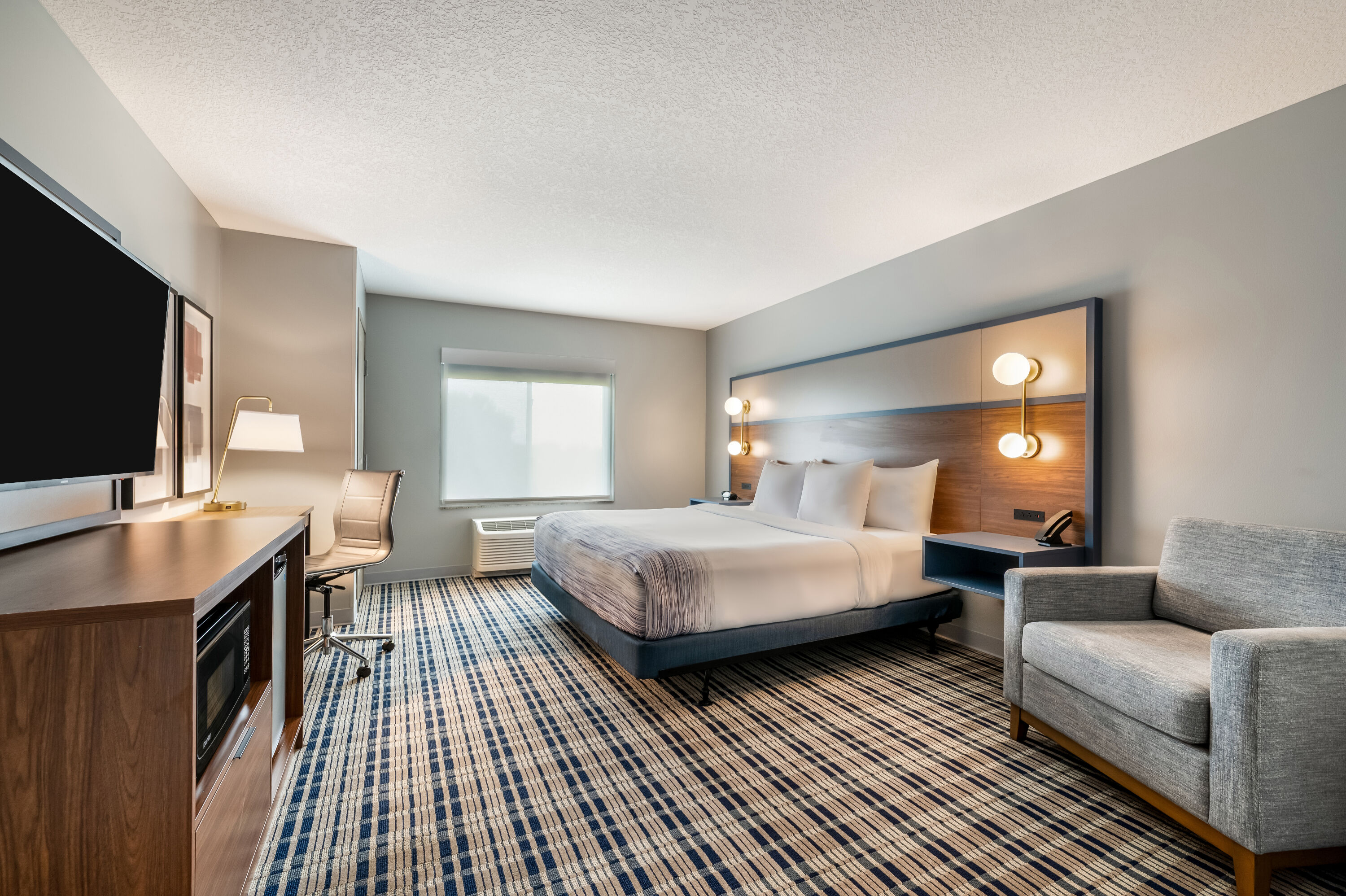King bed guest room at the AmericInn by Wyndham Fairfield in Fairfield, Iowa