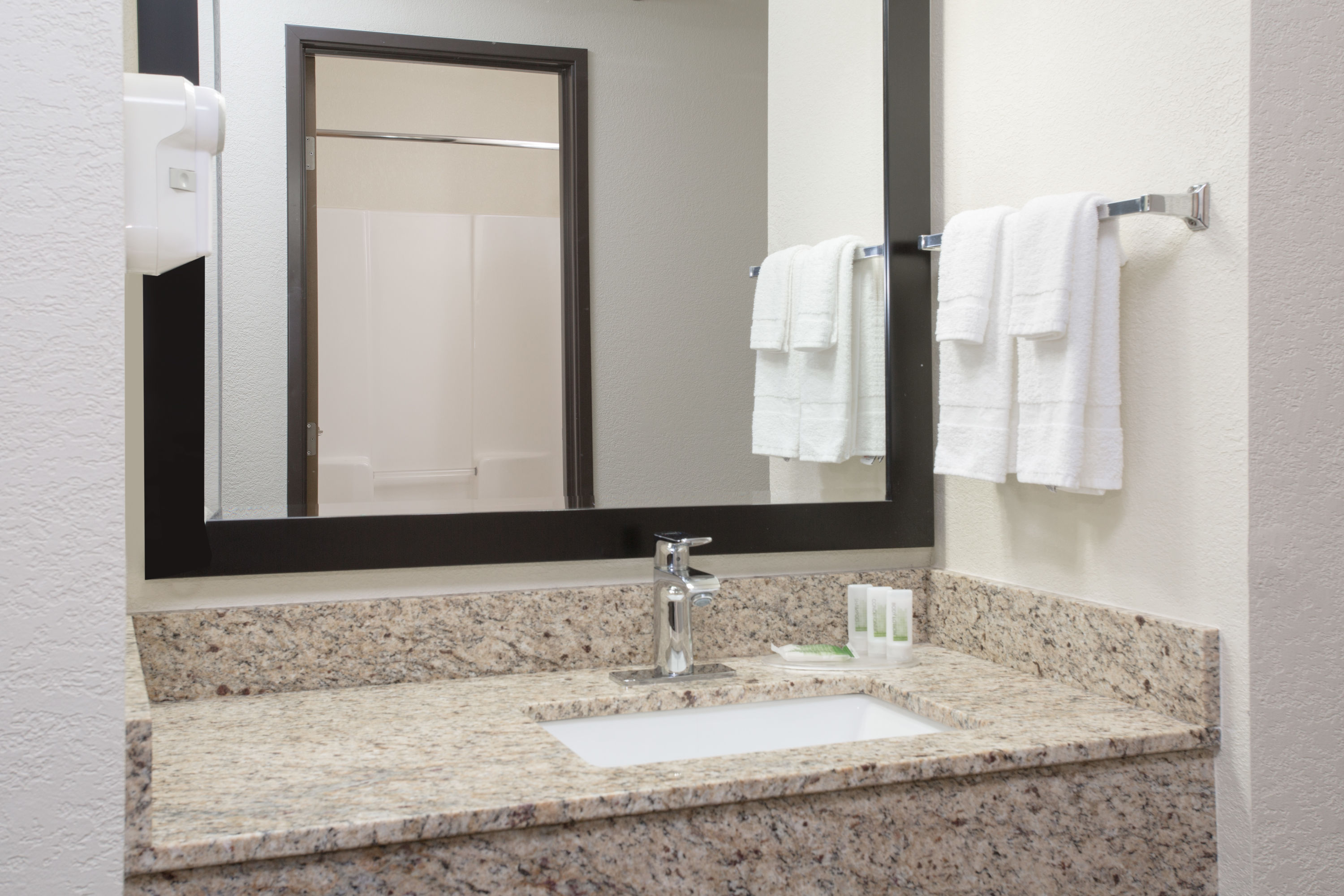 Guest room bath at the AmericInn by Wyndham Mount Pleasant in Mount Pleasant, Iowa