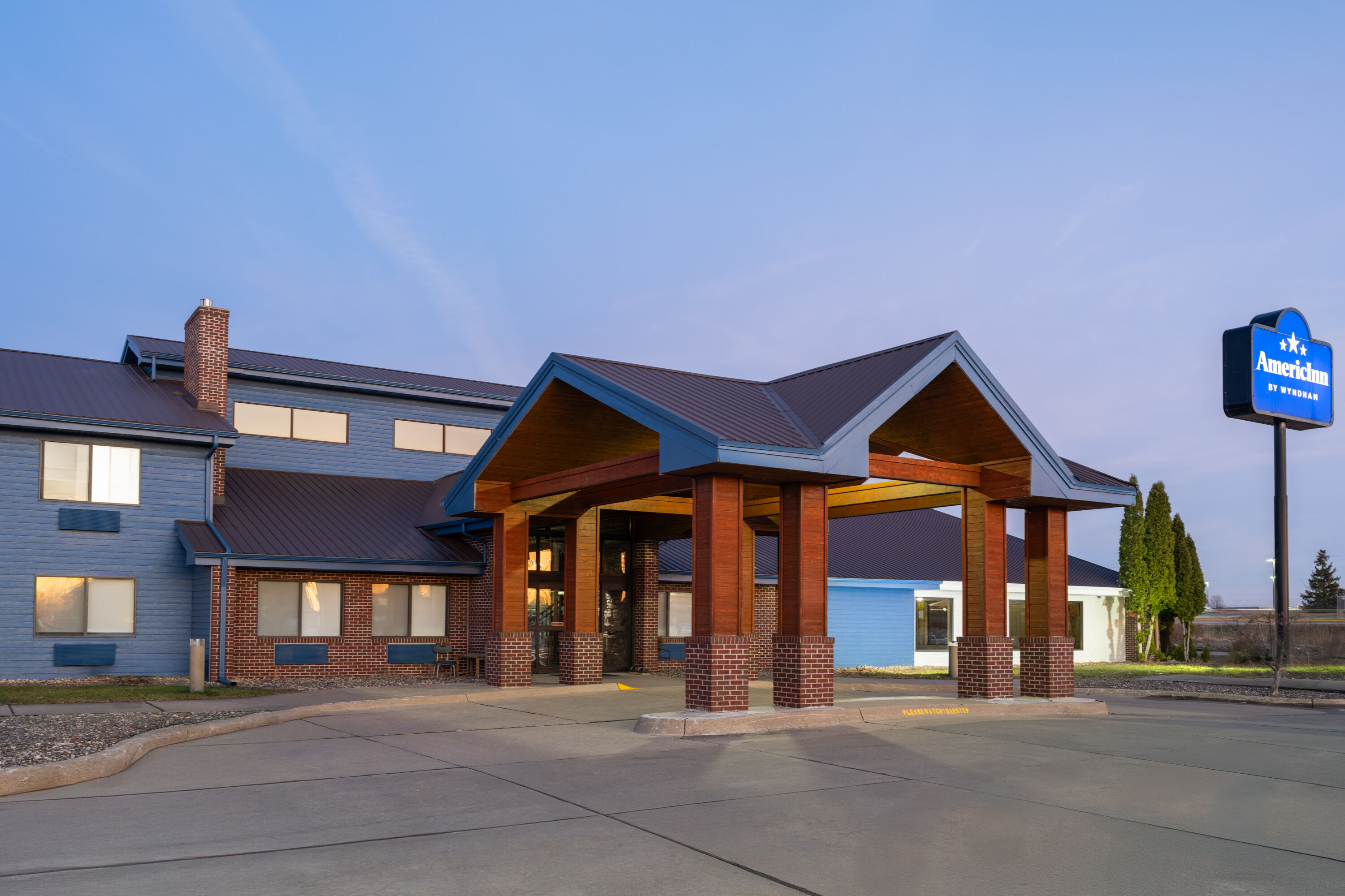 Exterior Dusk Image of AmericInn by Wyndham Muscatine hotel in Muscatine, Iowa
