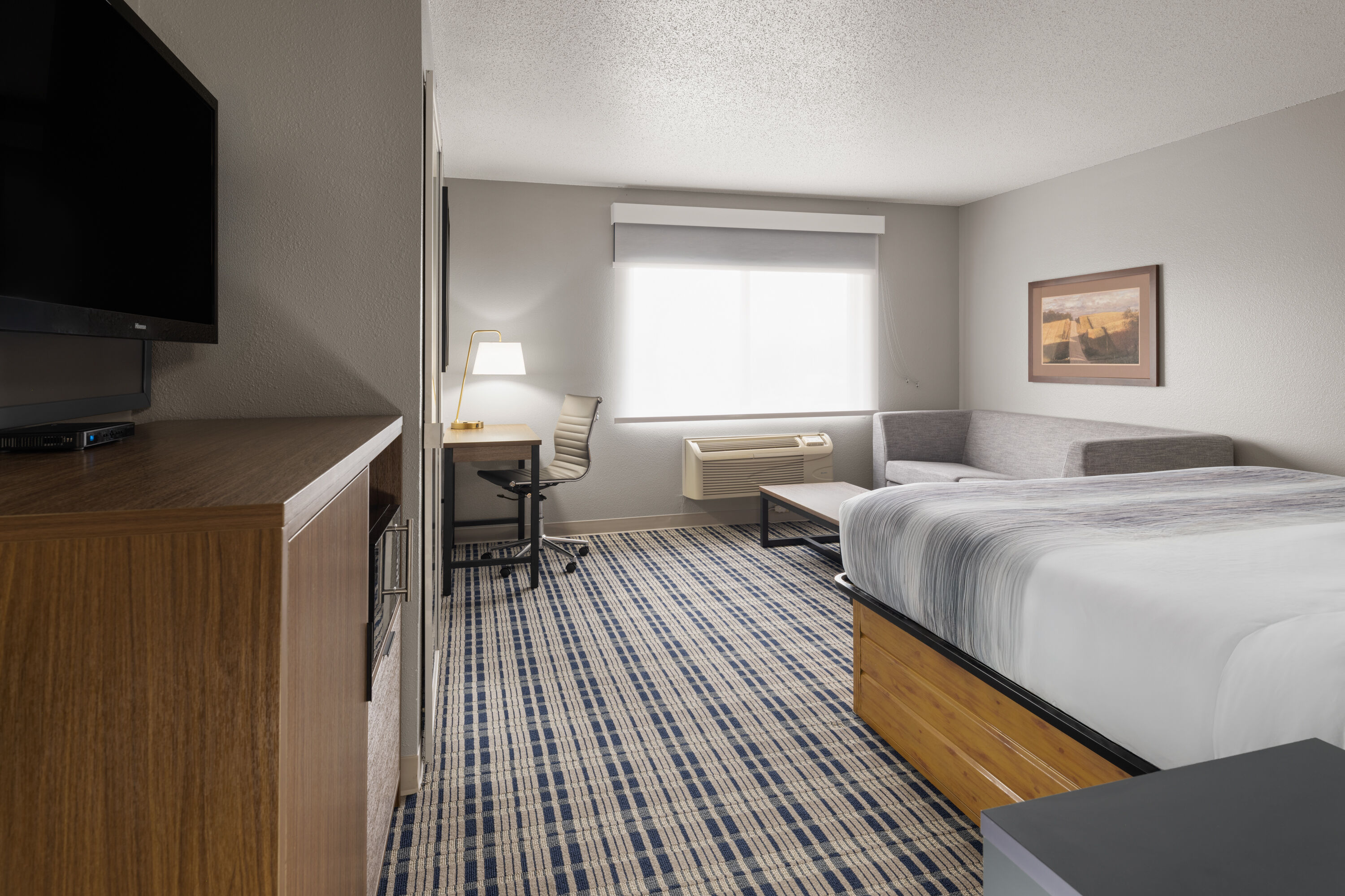 Guest room at the AmericInn by Wyndham Muscatine in Muscatine, Iowa