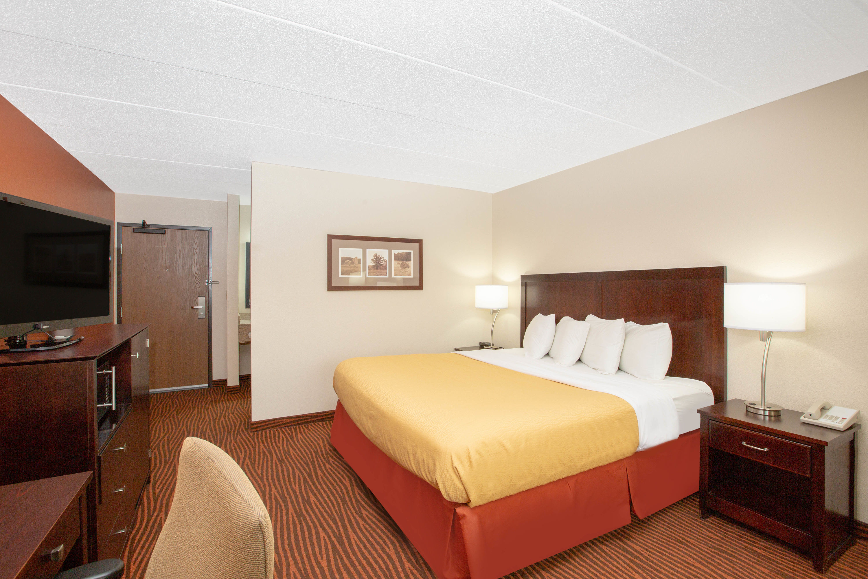 Guest room at the AmericInn by Wyndham Muscatine in Muscatine, Iowa