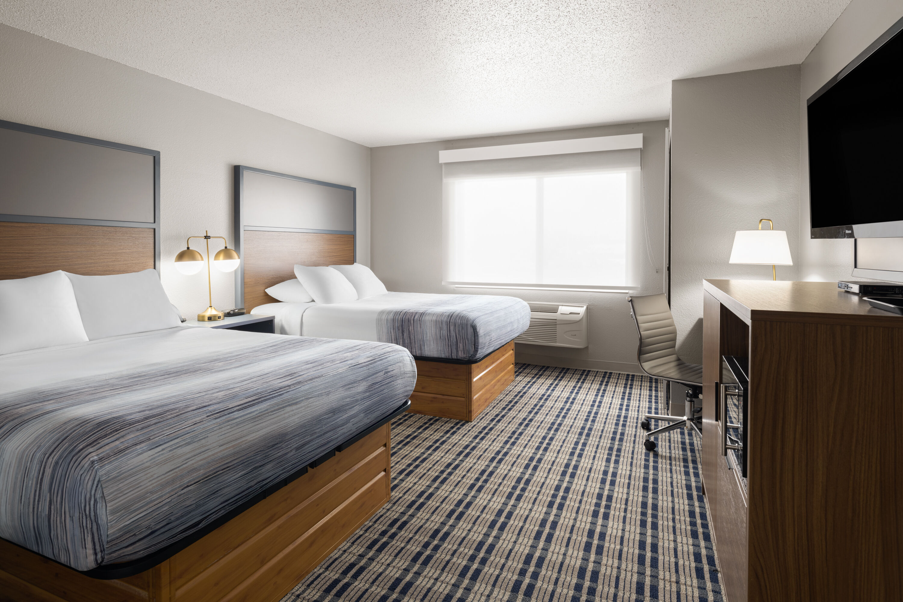 Guest room at the AmericInn by Wyndham Muscatine in Muscatine, Iowa