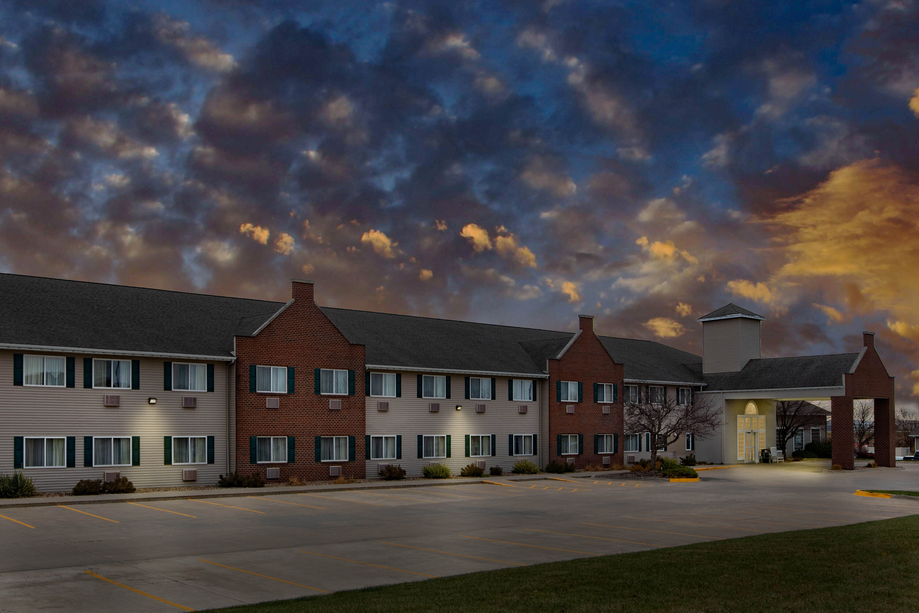 Exterior Dusk Image of AmericInn by Wyndham Pella hotel in Pella, Iowa