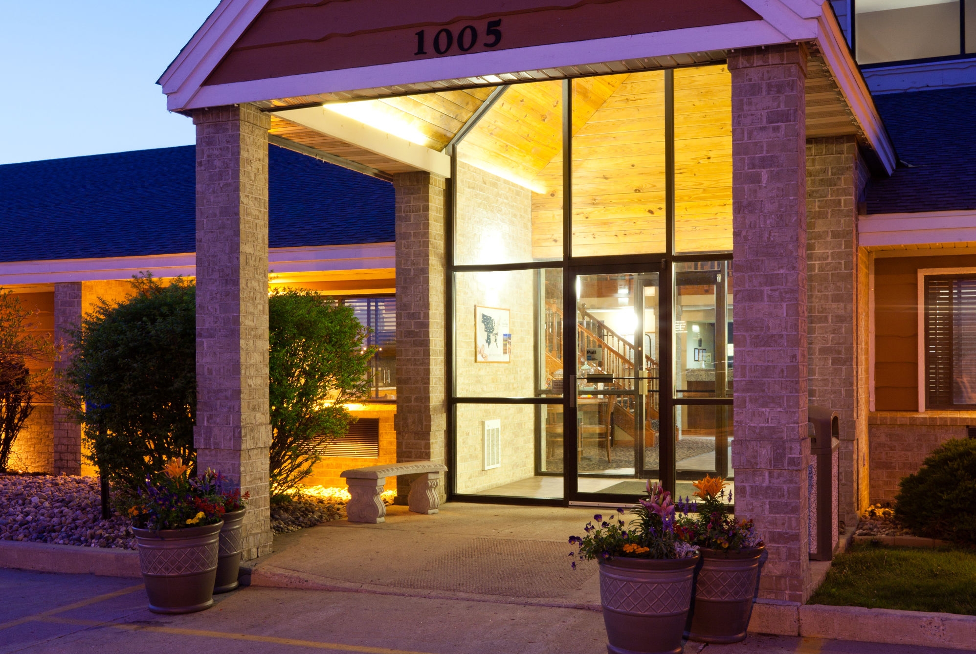 Exterior Dusk Image of AmericInn by Wyndham Spencer hotel in Spencer, Iowa