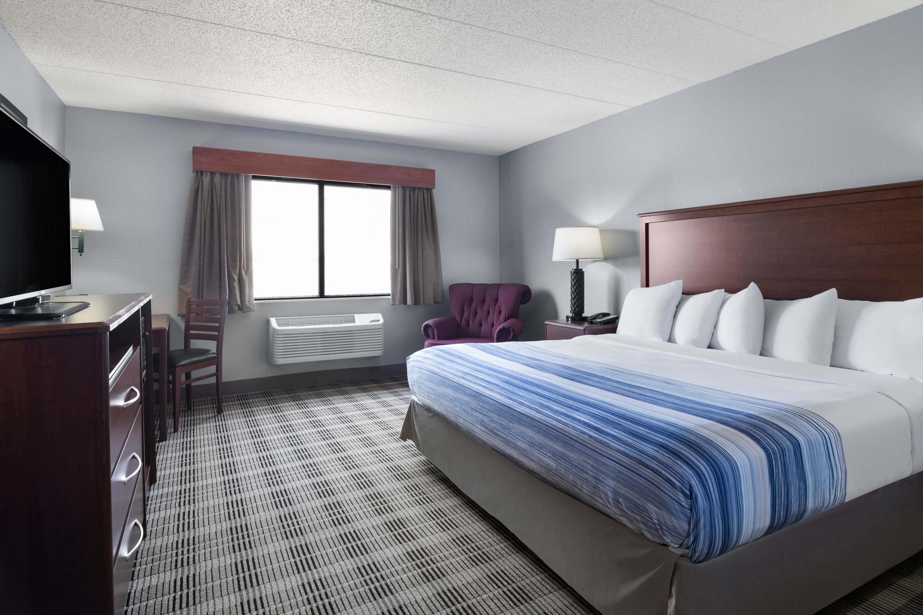 Guest room at the AmericInn by Wyndham Stuart in Stuart, Iowa