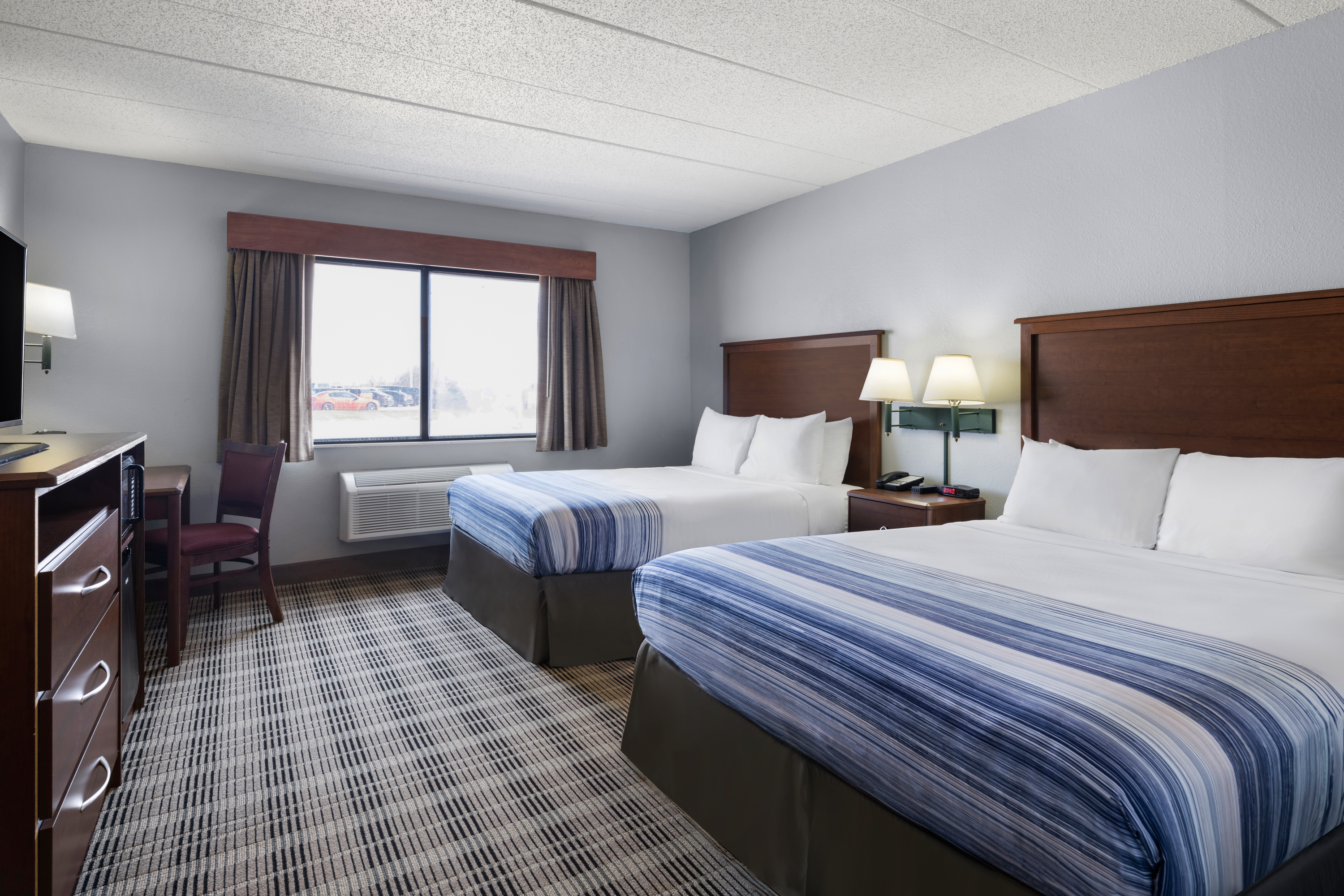 Guest room at the AmericInn by Wyndham Stuart in Stuart, Iowa