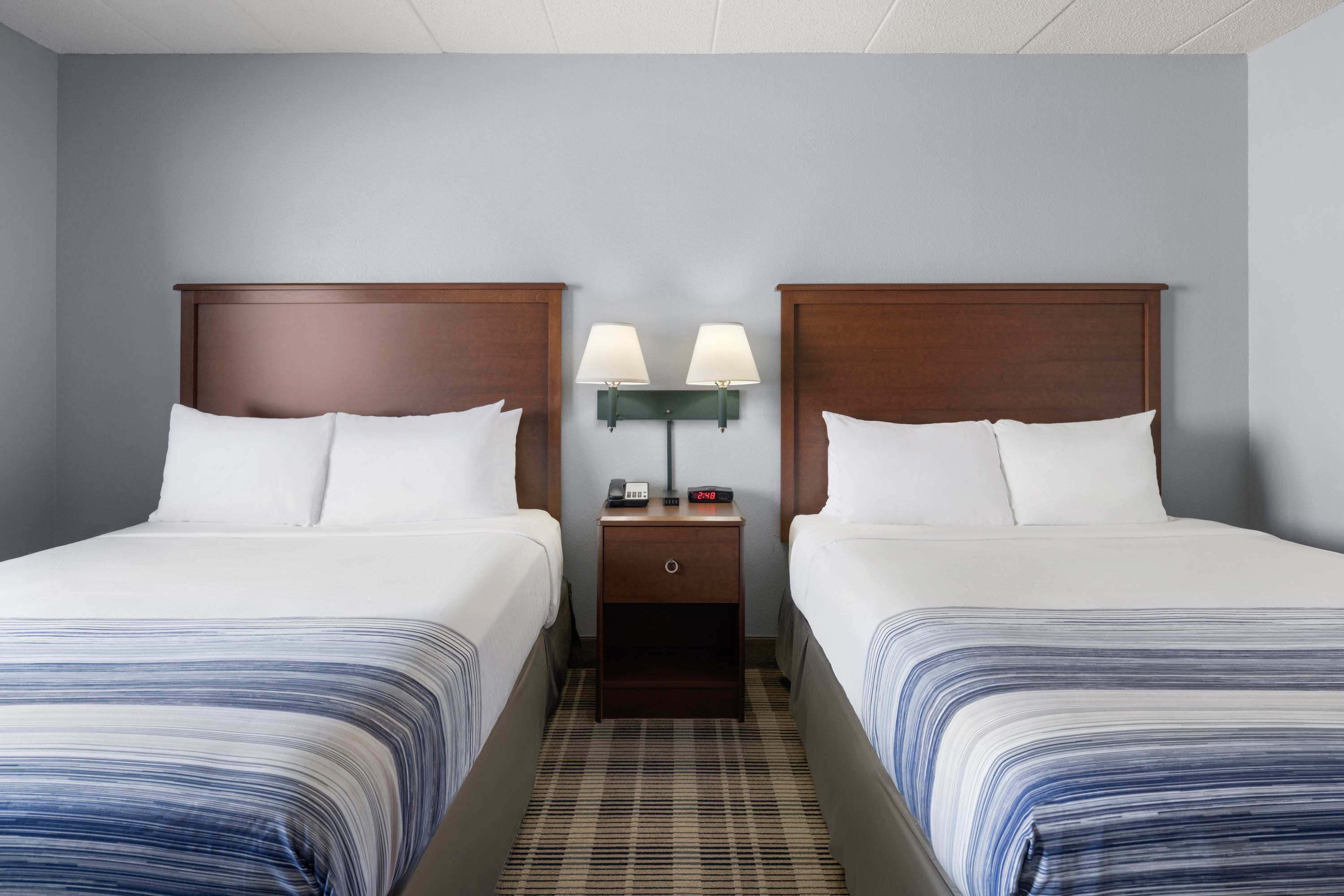 Guest room at the AmericInn by Wyndham Stuart in Stuart, Iowa
