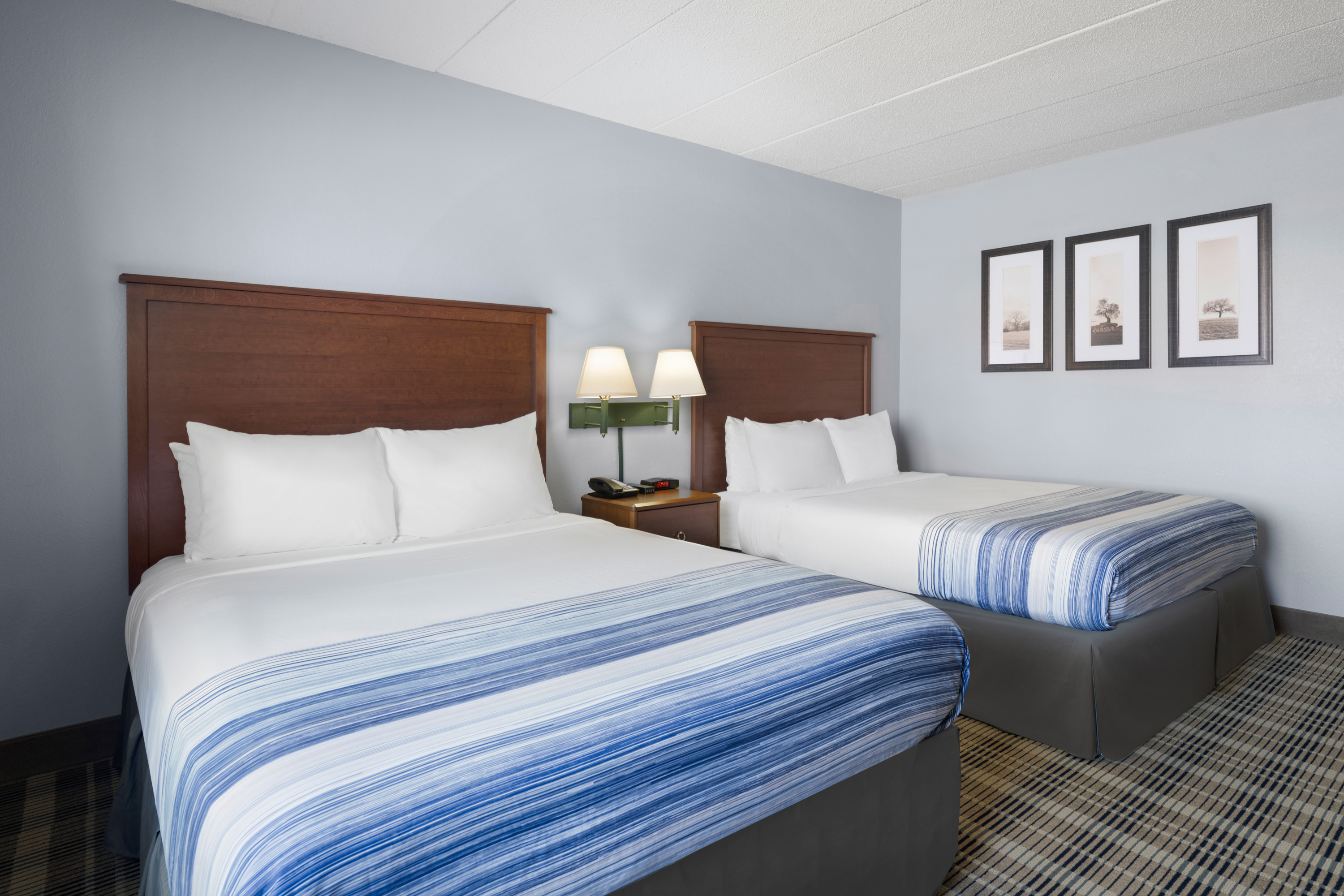 Guest room at the AmericInn by Wyndham Stuart in Stuart, Iowa