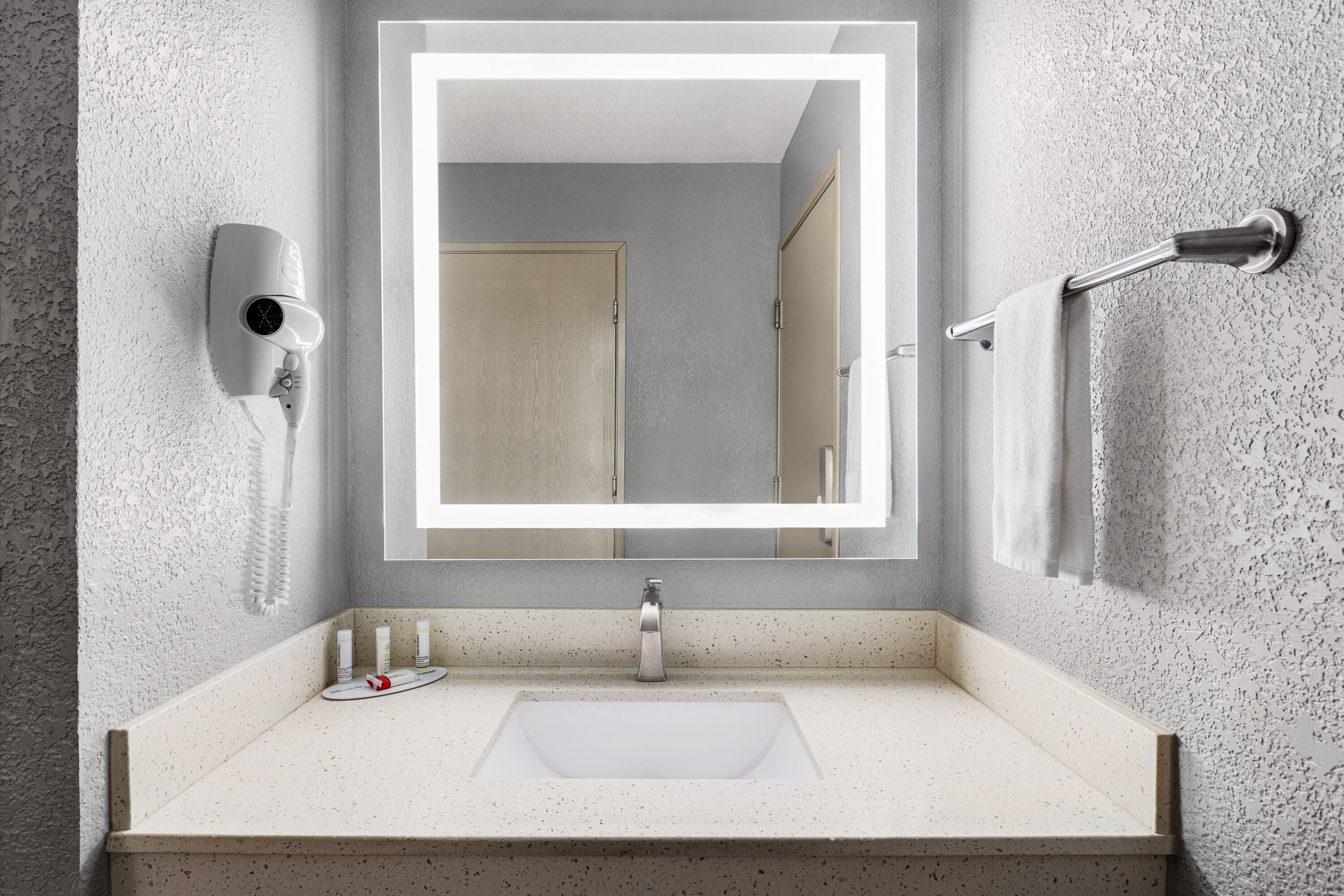 Guest room bath at the AmericInn by Wyndham Williamsburg in Williamsburg, Iowa