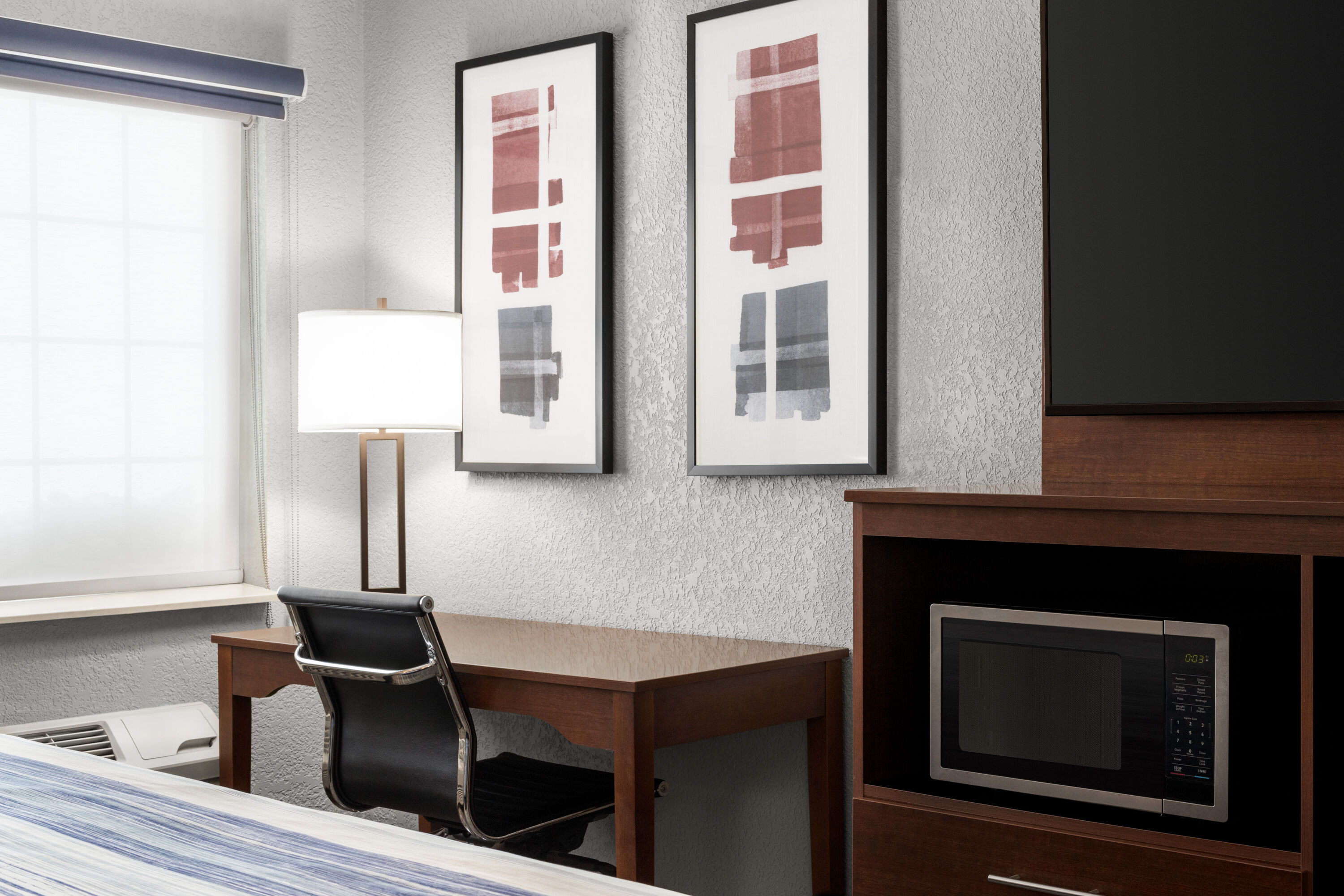 Guest room at the AmericInn by Wyndham Williamsburg in Williamsburg, Iowa