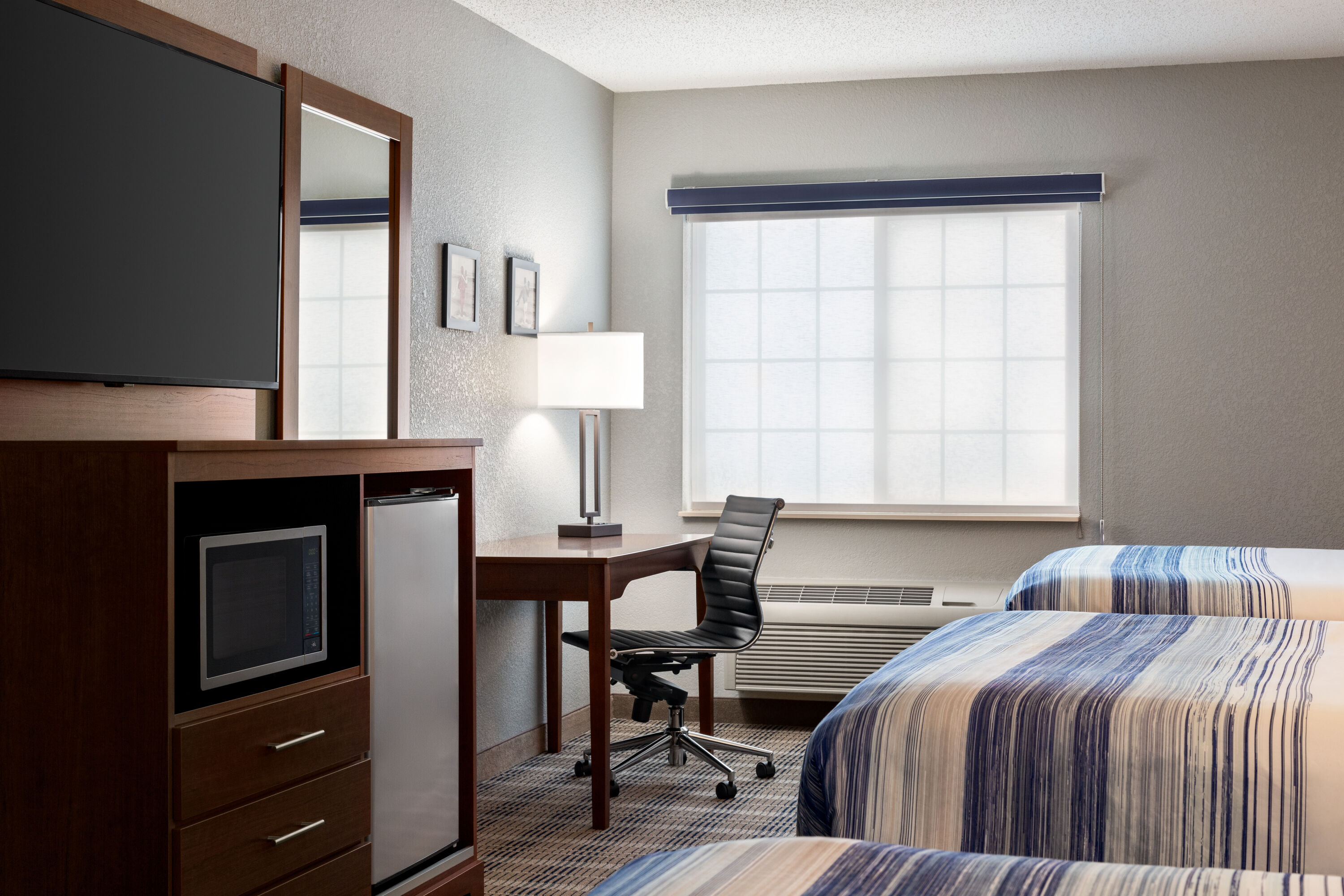 Guest room at the AmericInn by Wyndham Williamsburg in Williamsburg, Iowa