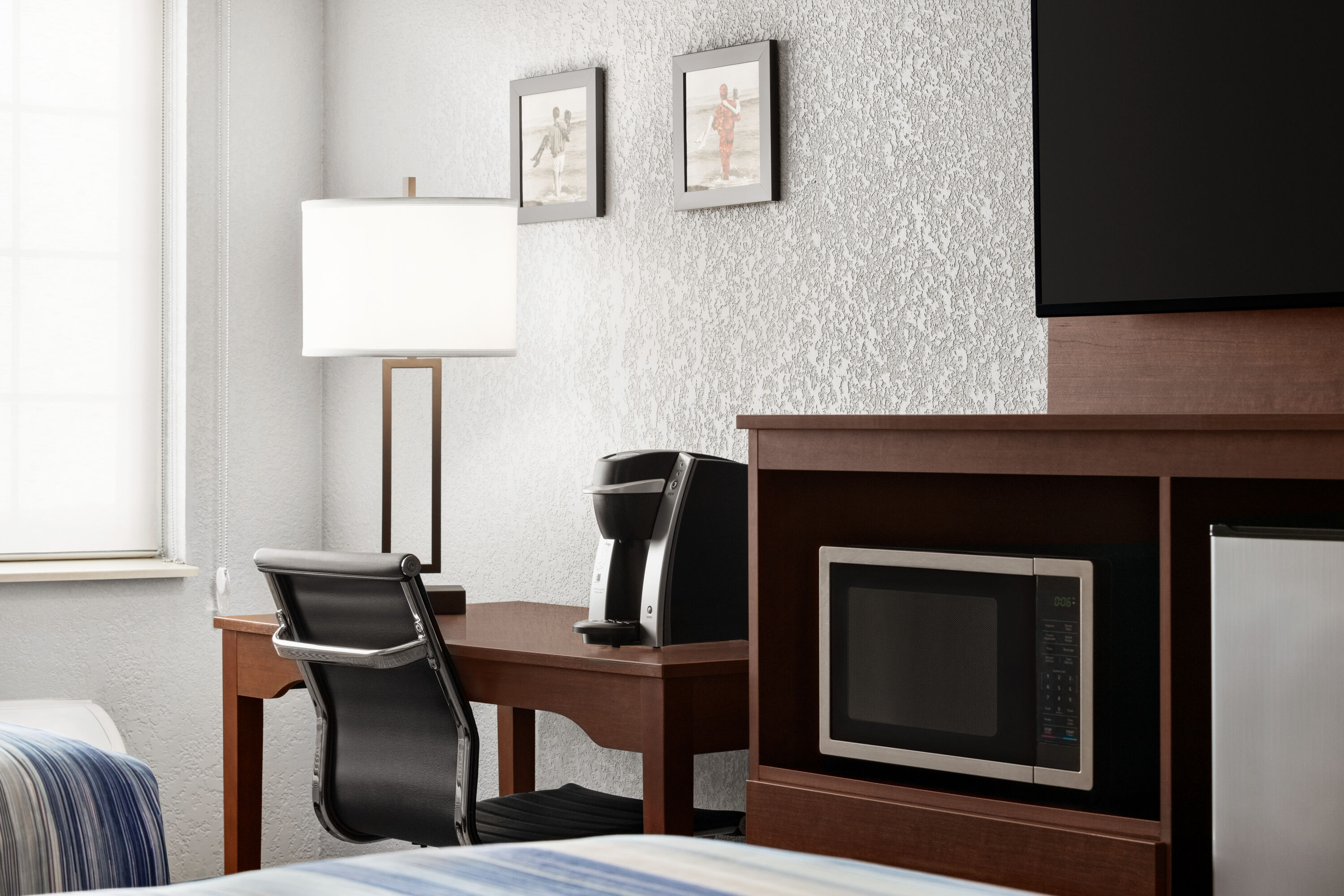 Guest room at the AmericInn by Wyndham Williamsburg in Williamsburg, Iowa