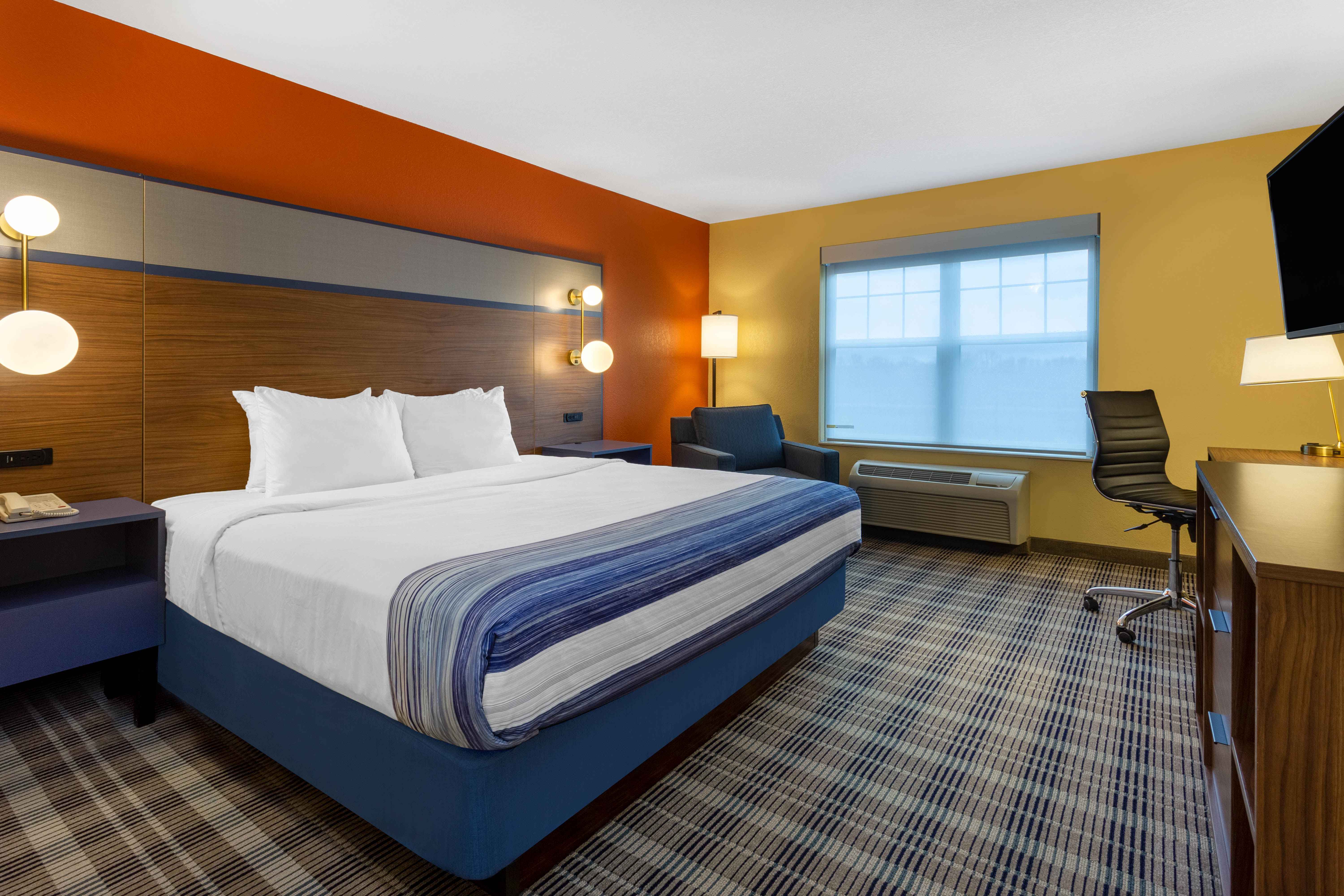 Guest room at the AmericInn by Wyndham Fulton Clinton in Fulton, Illinois