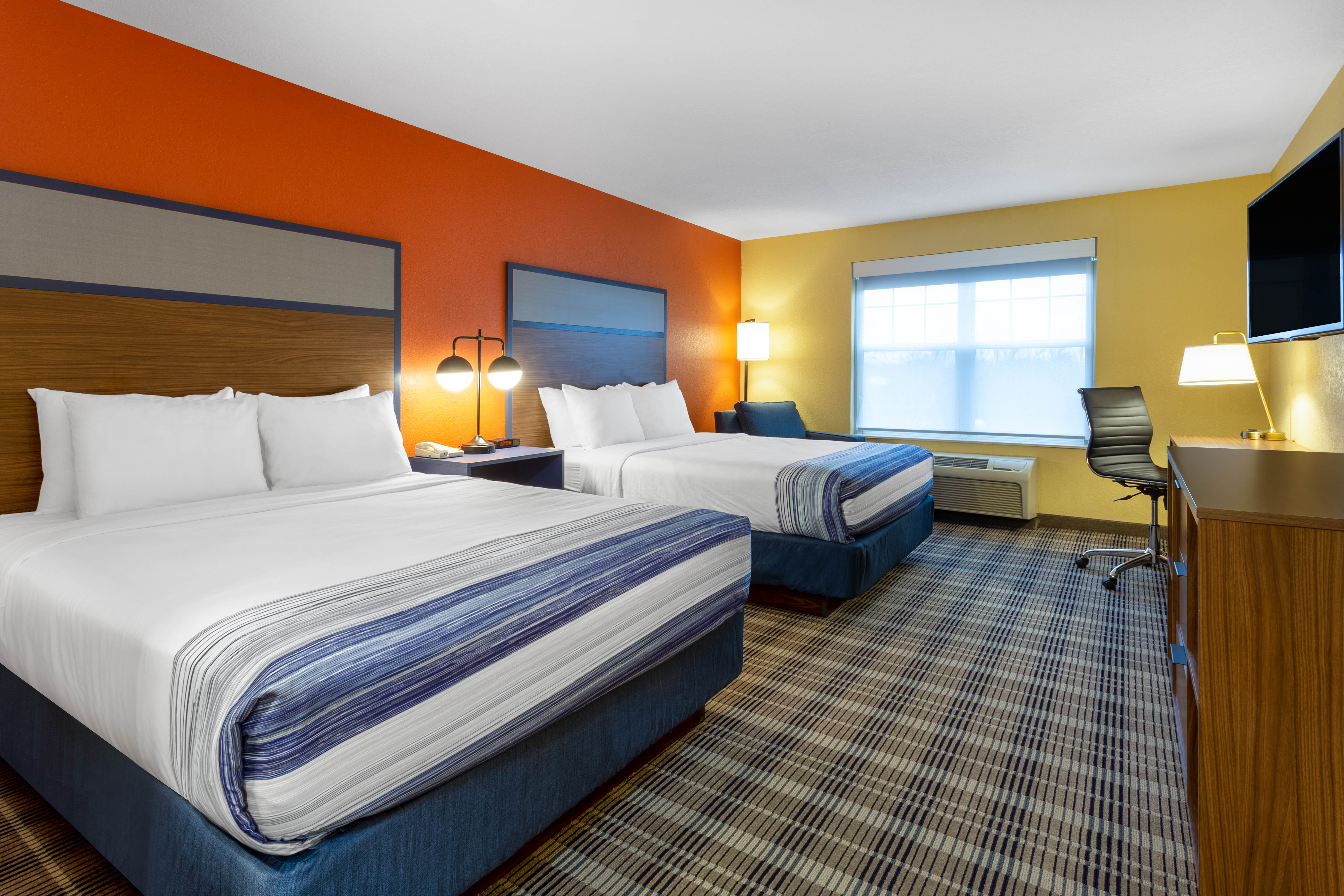 Guest room at the AmericInn by Wyndham Fulton Clinton in Fulton, Illinois