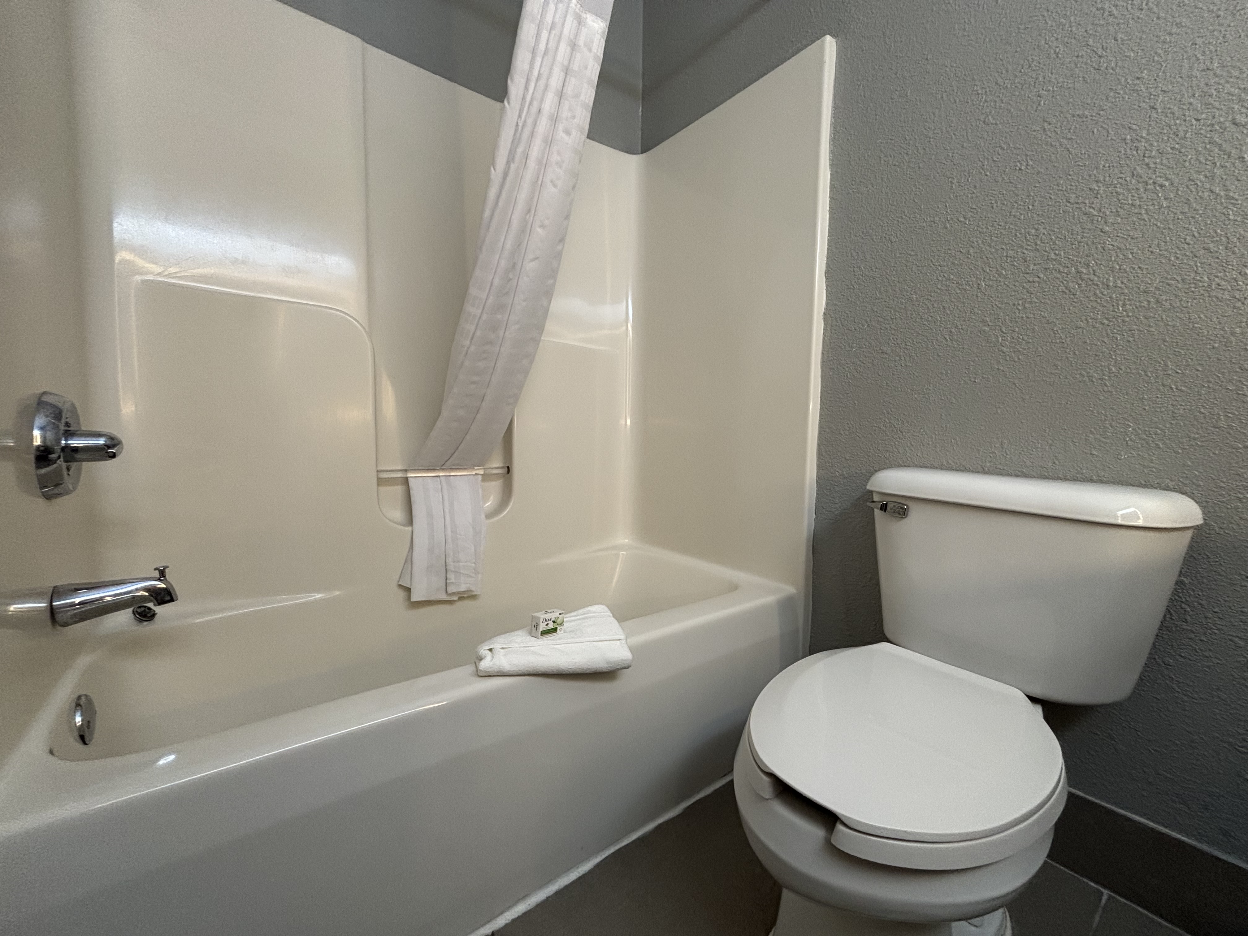 Guest room bath at the AmericInn by Wyndham Galesburg in Galesburg, Illinois