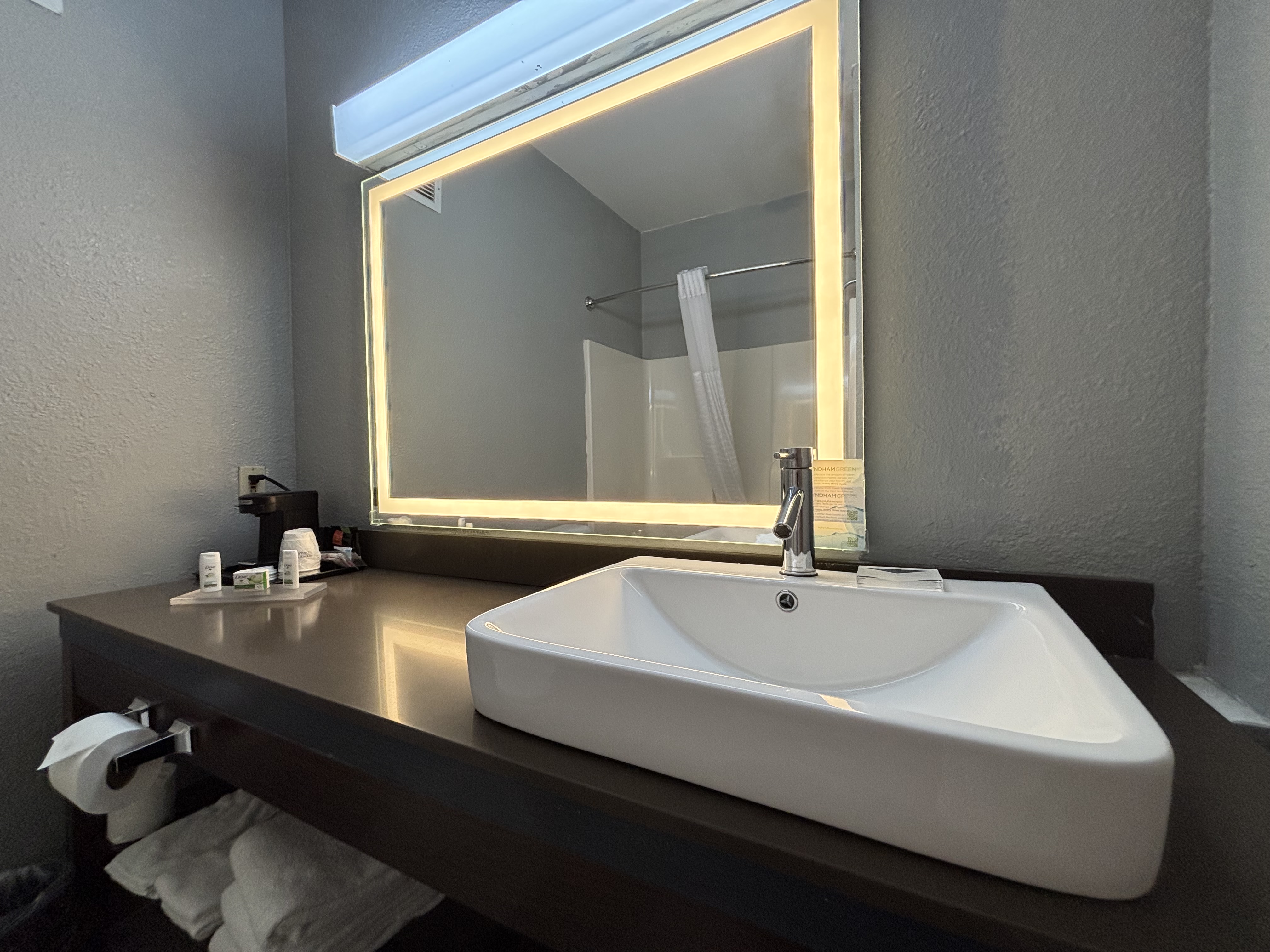 Guest room bath at the AmericInn by Wyndham Galesburg in Galesburg, Illinois