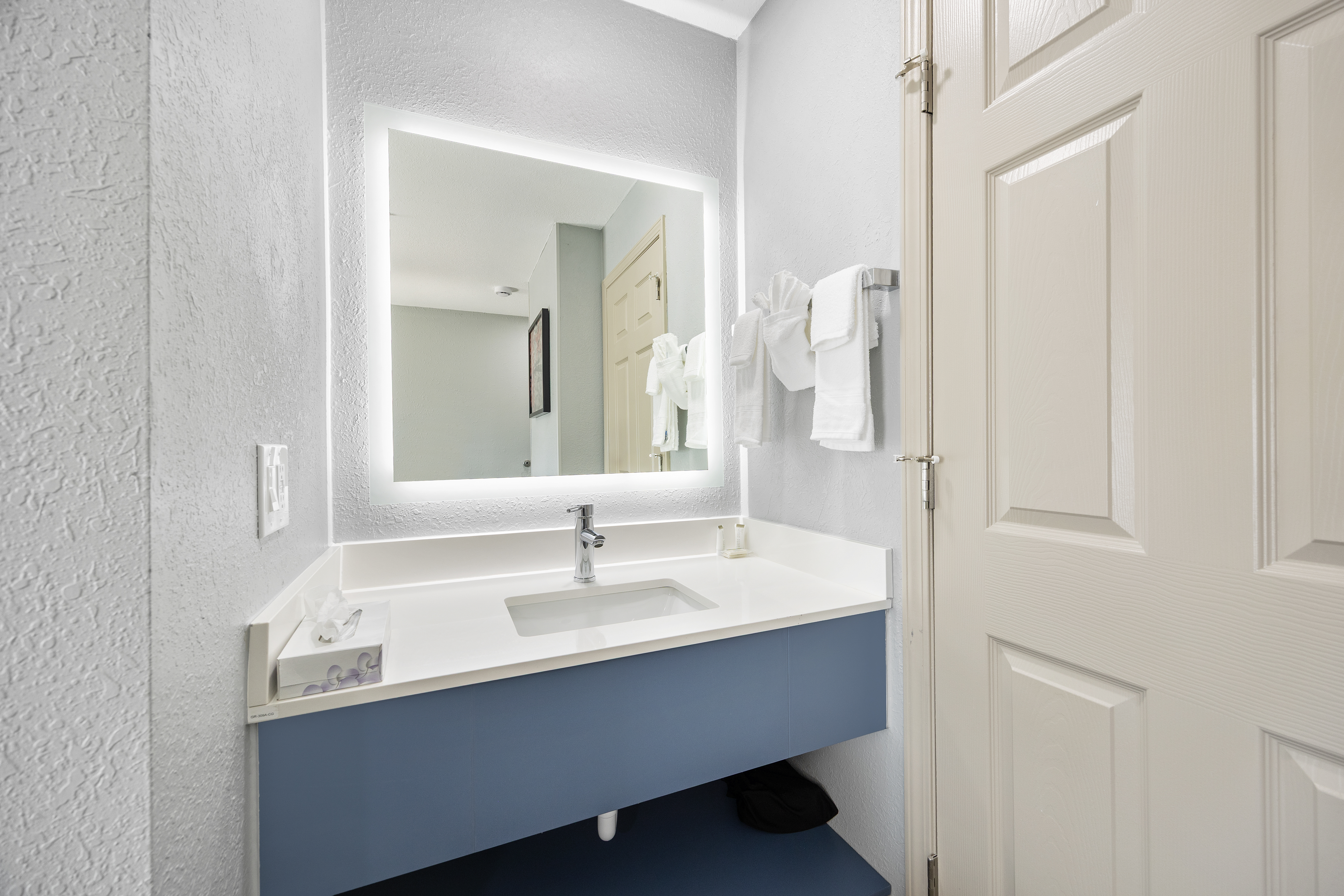 Guest room bath at the AmericInn by Wyndham Urbana/Champaign University Area in Urbana, Illinois
