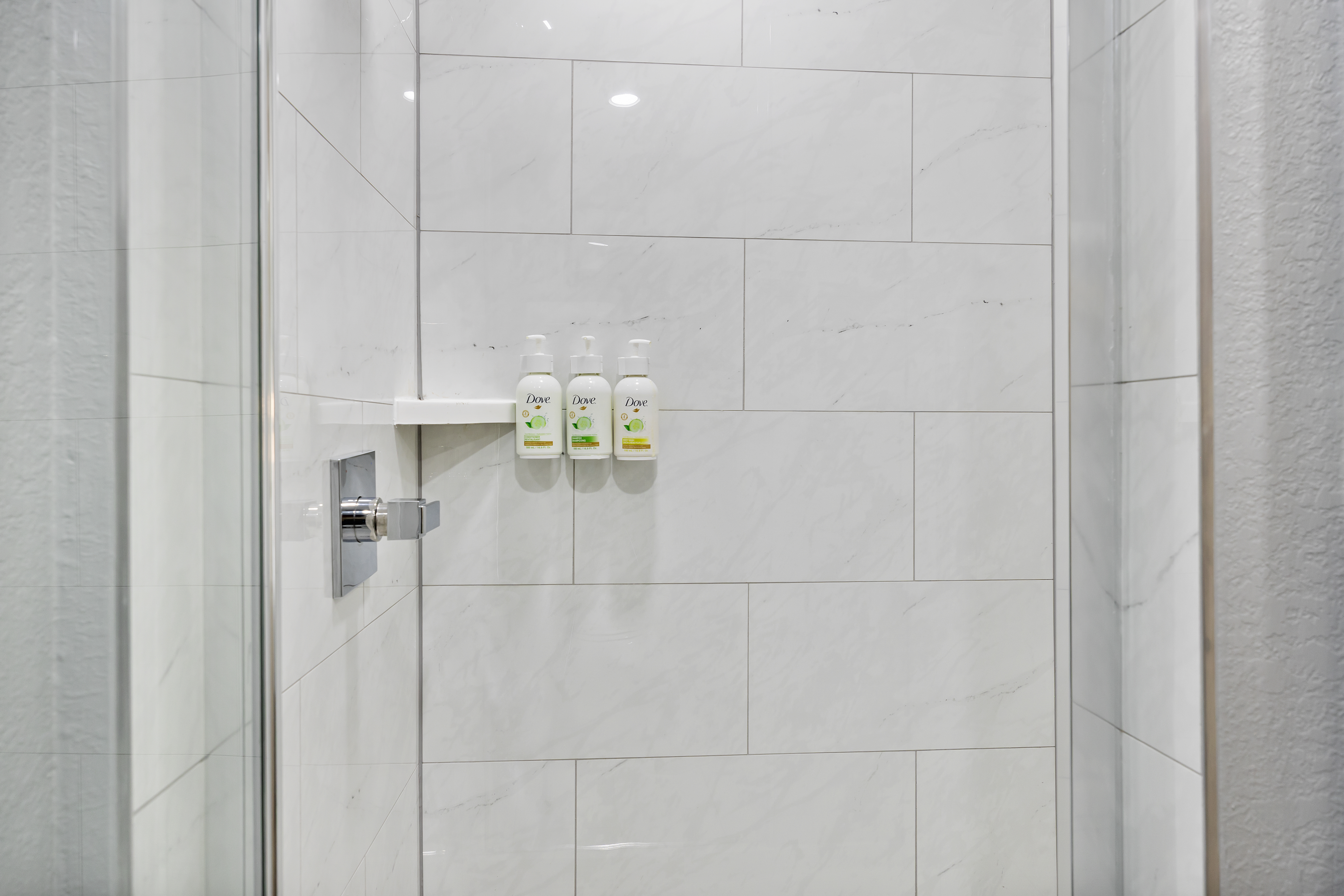 Guest room bath at the AmericInn by Wyndham Urbana/Champaign University Area in Urbana, Illinois