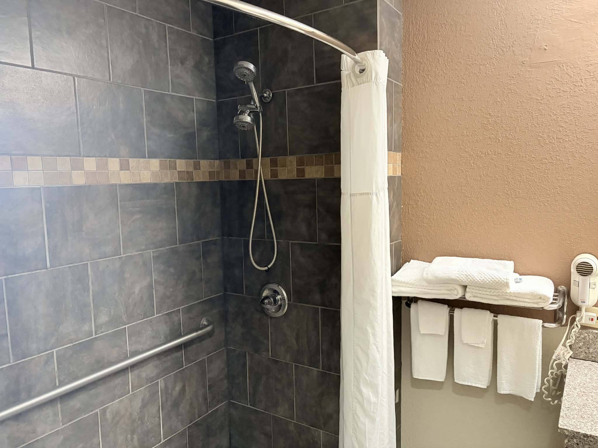 Guest room bath at the AmericInn by Wyndham Holland MI in Holland, Michigan