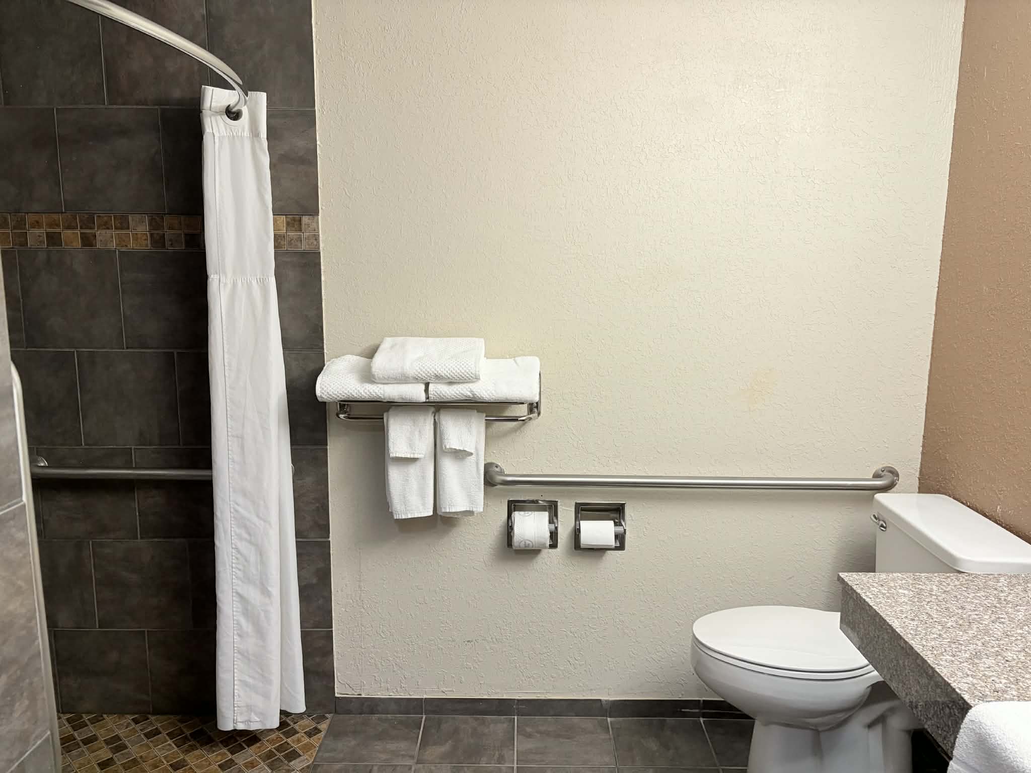 Guest room bath at the AmericInn by Wyndham Holland MI in Holland, Michigan