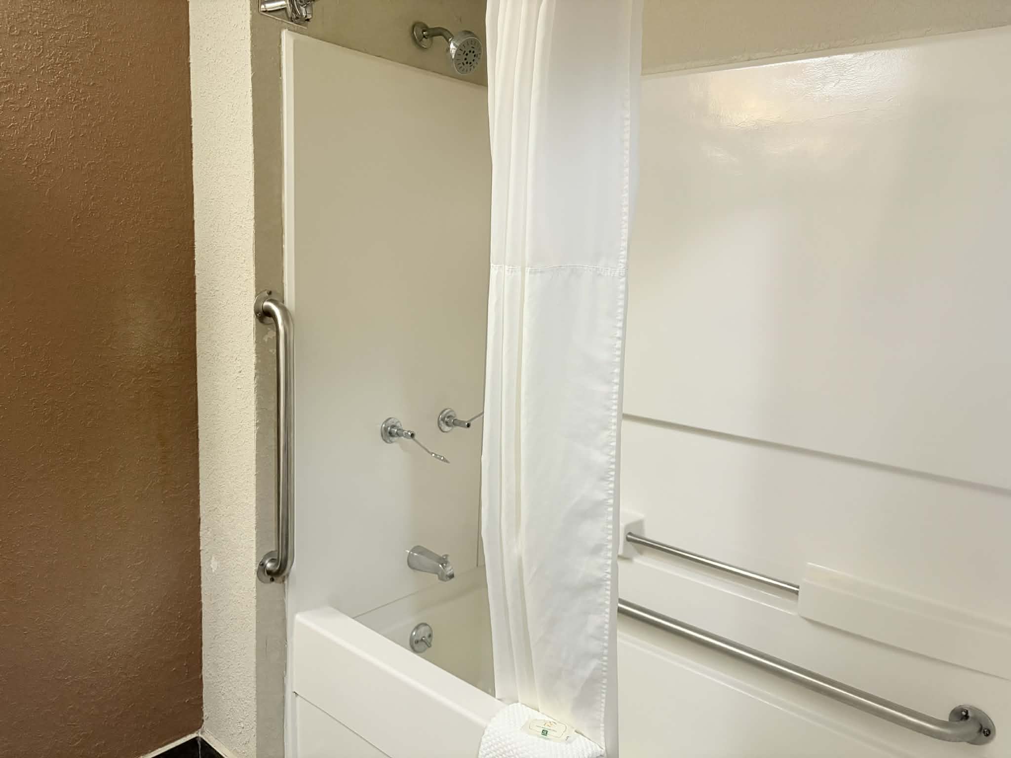 Guest room bath at the AmericInn by Wyndham Holland MI in Holland, Michigan