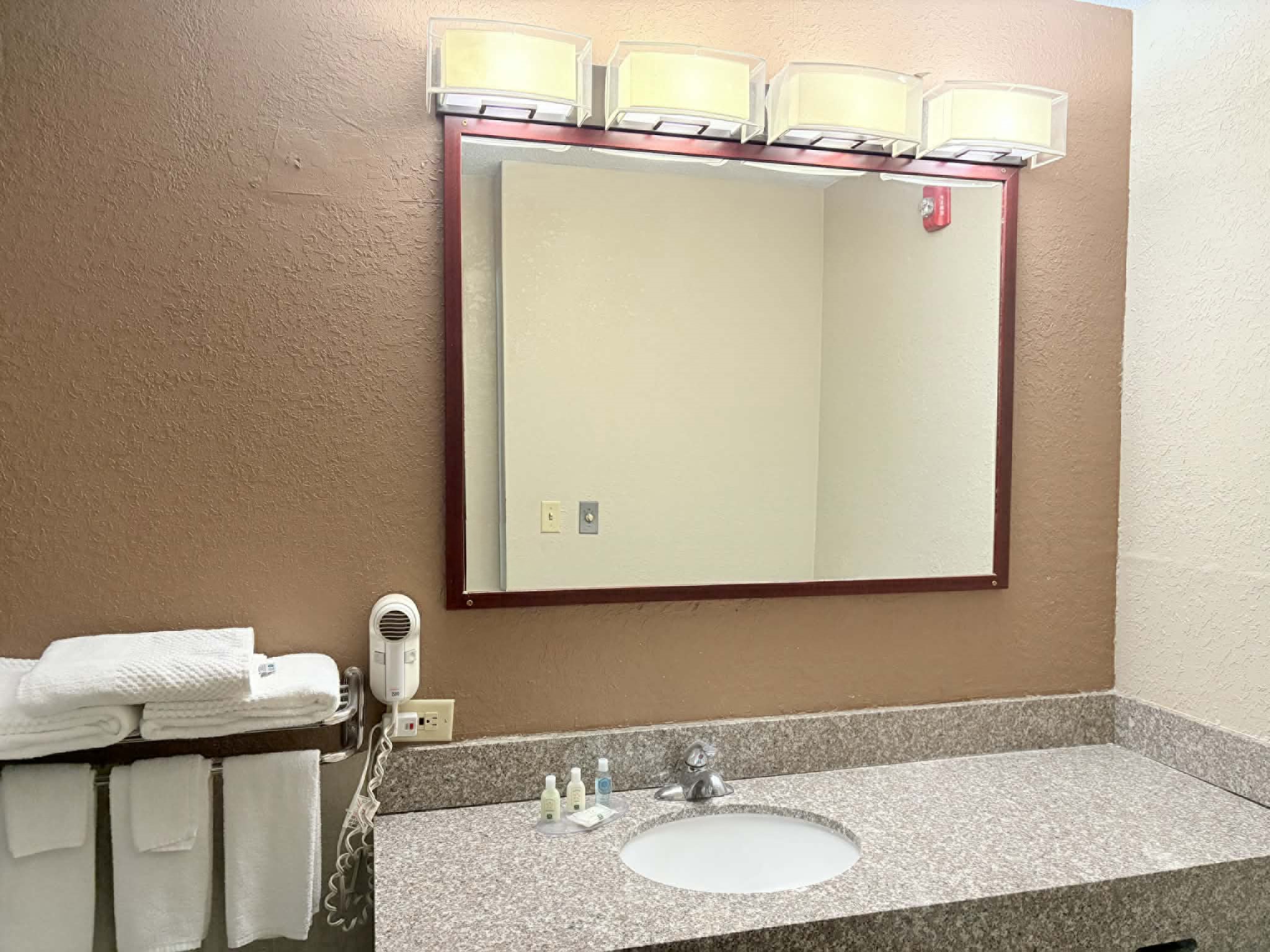 Guest room bath at the AmericInn by Wyndham Holland MI in Holland, Michigan