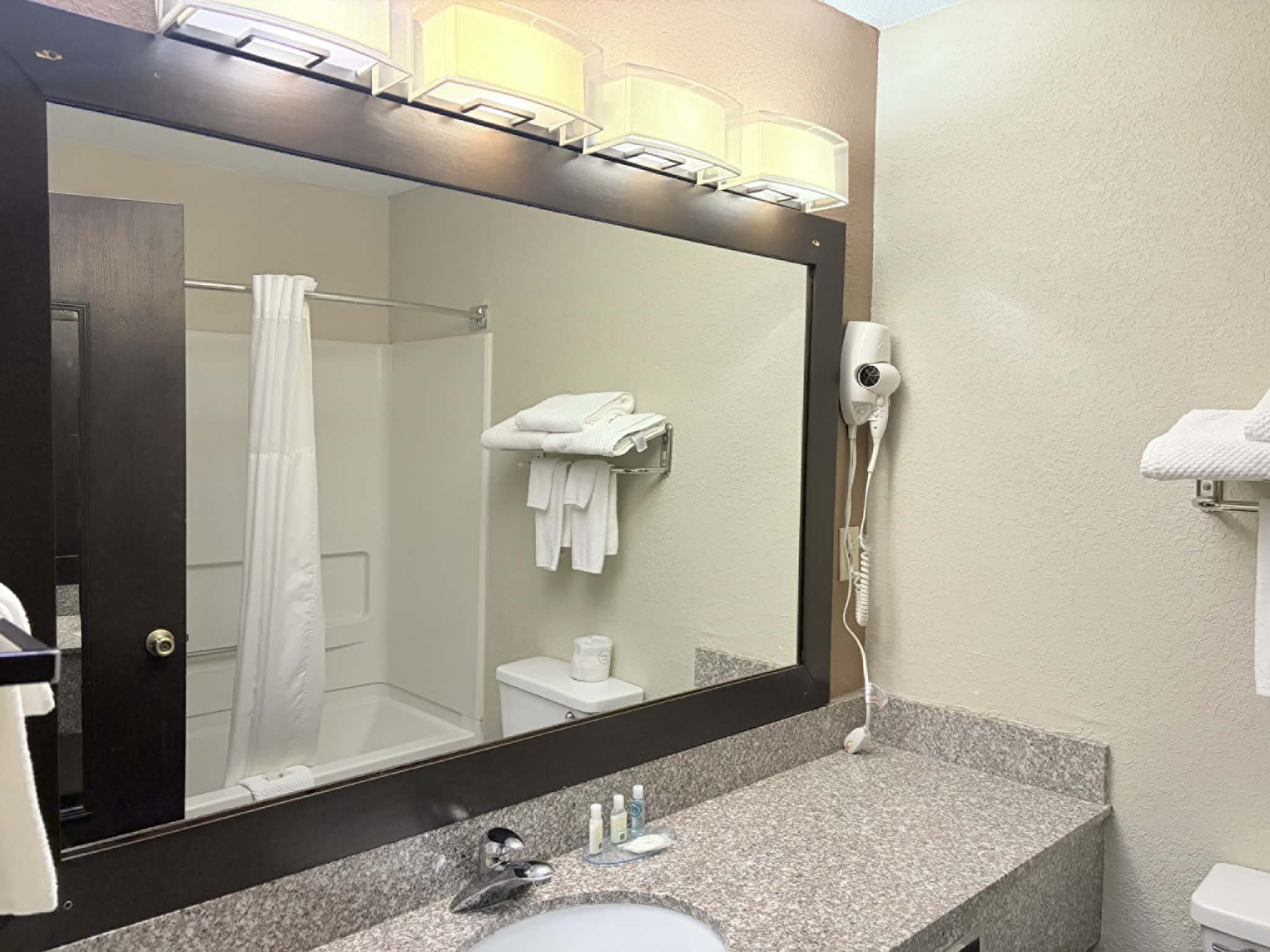Guest room bath at the AmericInn by Wyndham Holland MI in Holland, Michigan