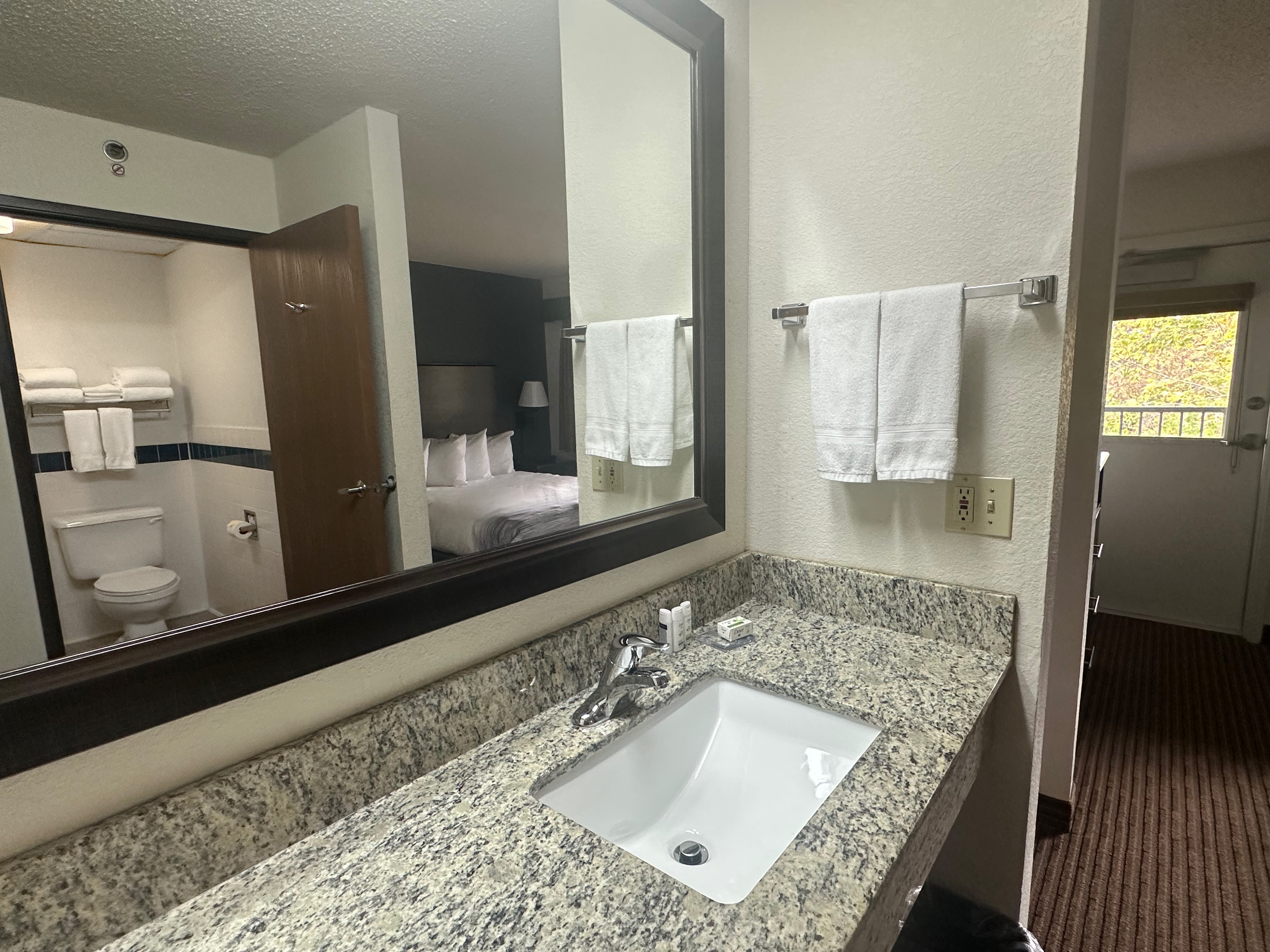 Guest room bath at the AmericInn by Wyndham Menominee in Menominee, Michigan