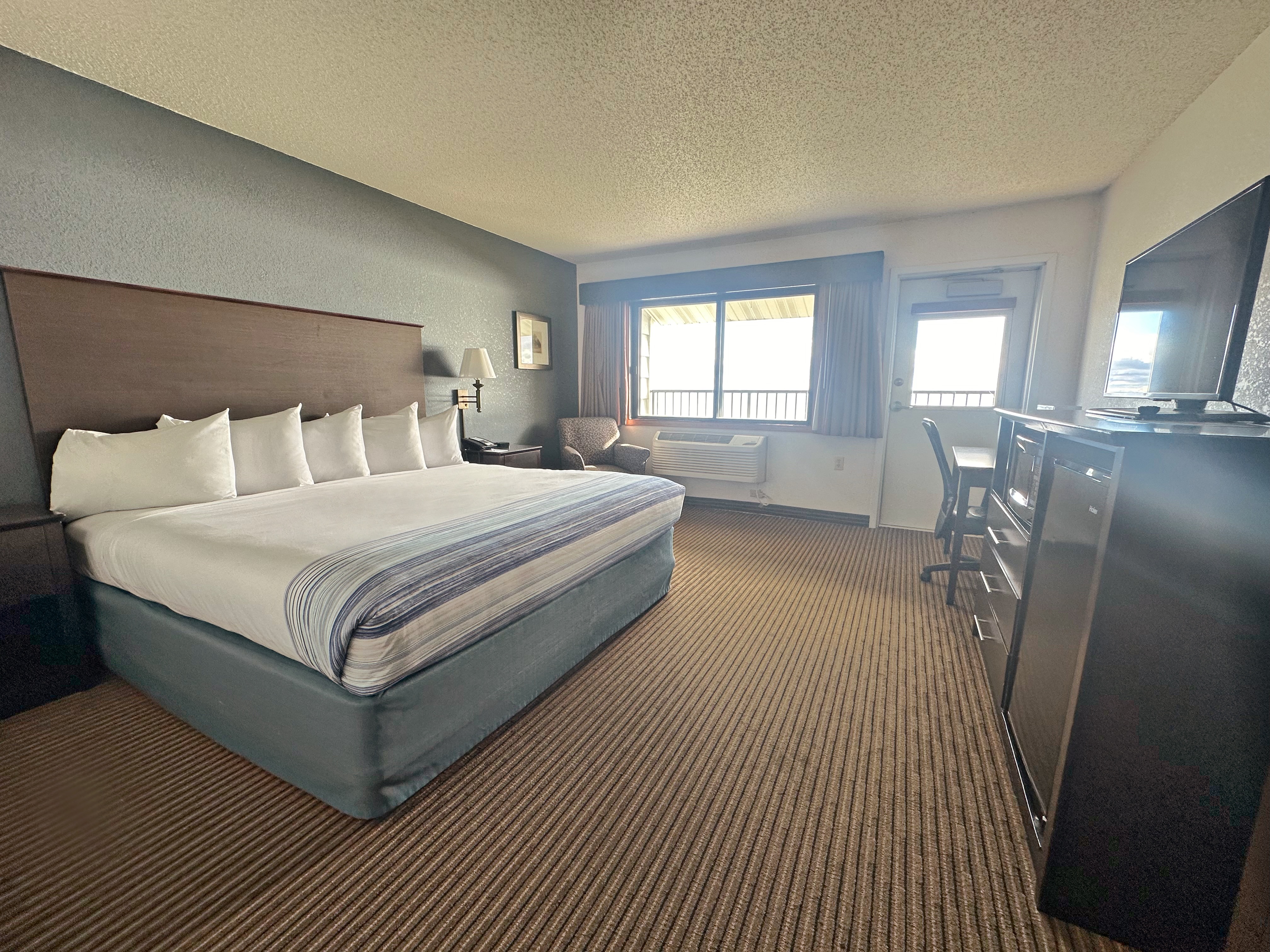 Guest room at the AmericInn by Wyndham Menominee in Menominee, Michigan