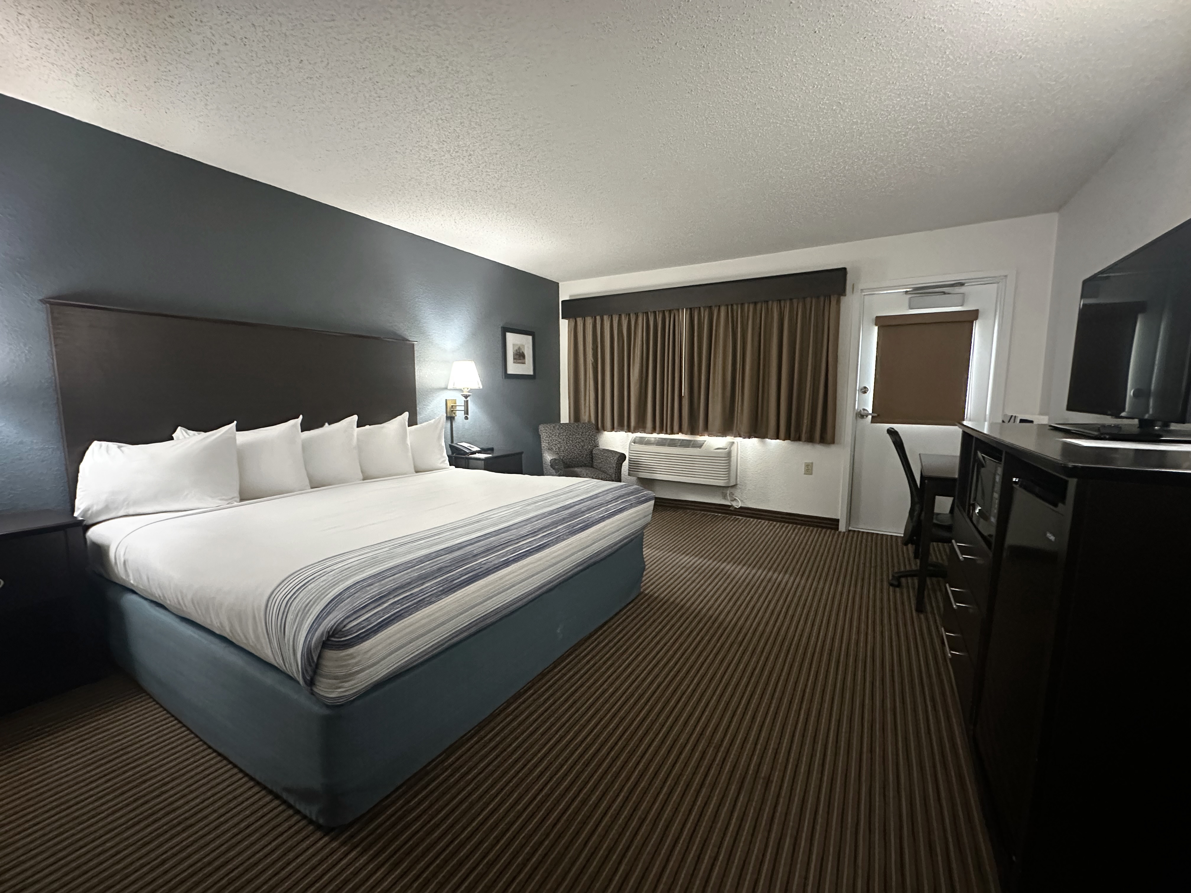 Guest room at the AmericInn by Wyndham Menominee in Menominee, Michigan