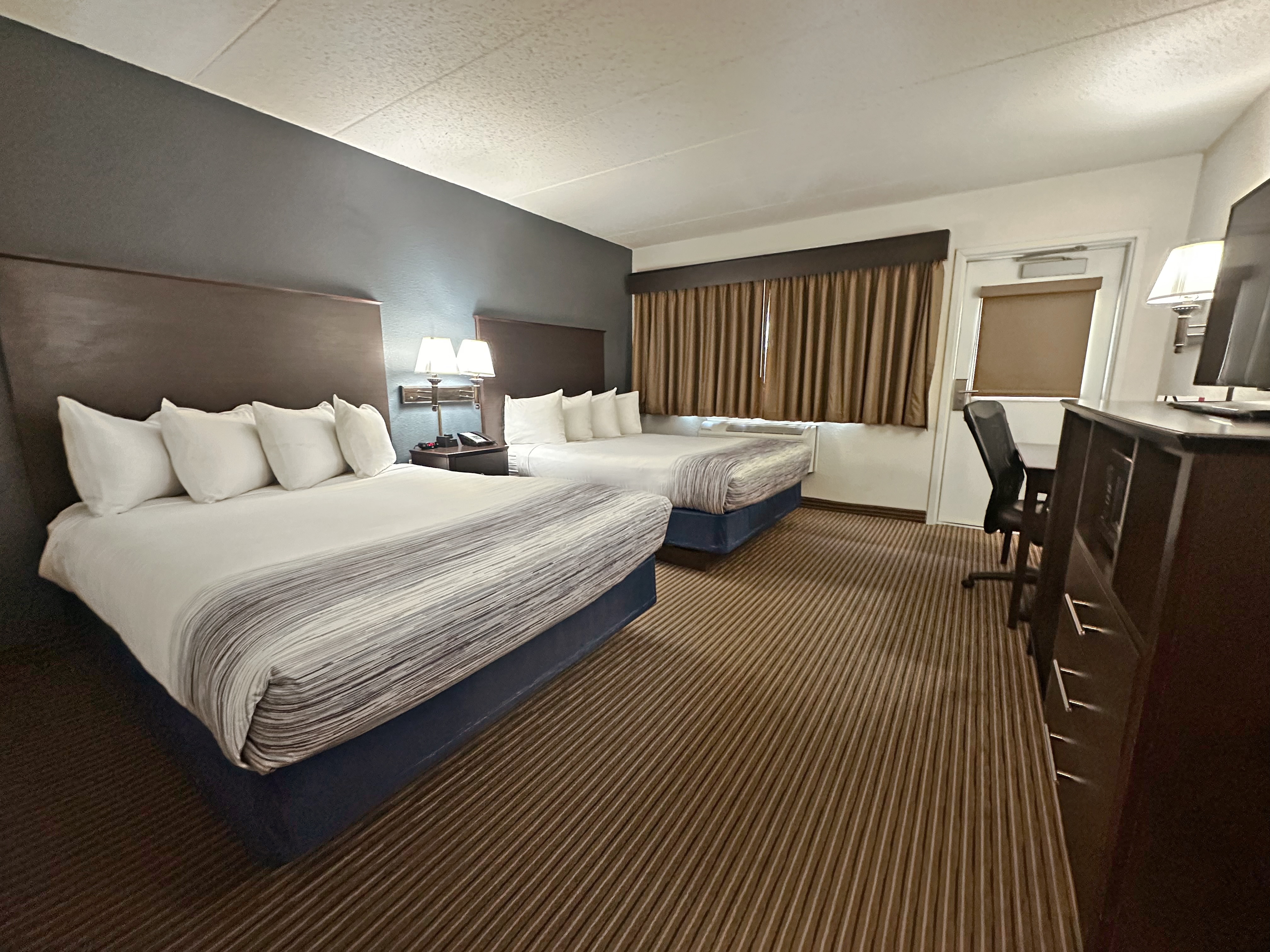 Guest room at the AmericInn by Wyndham Menominee in Menominee, Michigan