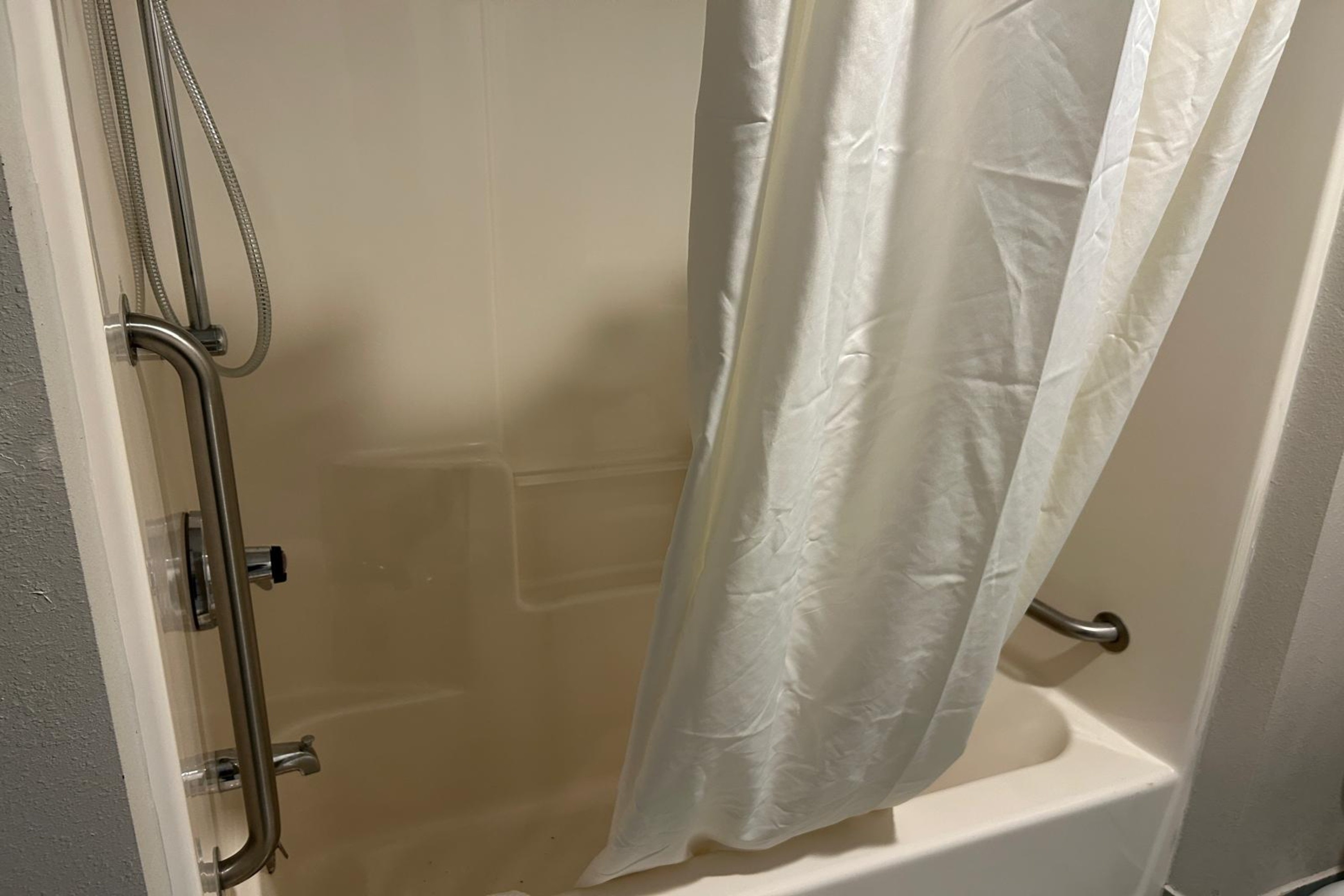 Guest room bath at the AmericInn by Wyndham Saint Ignace in Saint Ignace, Michigan