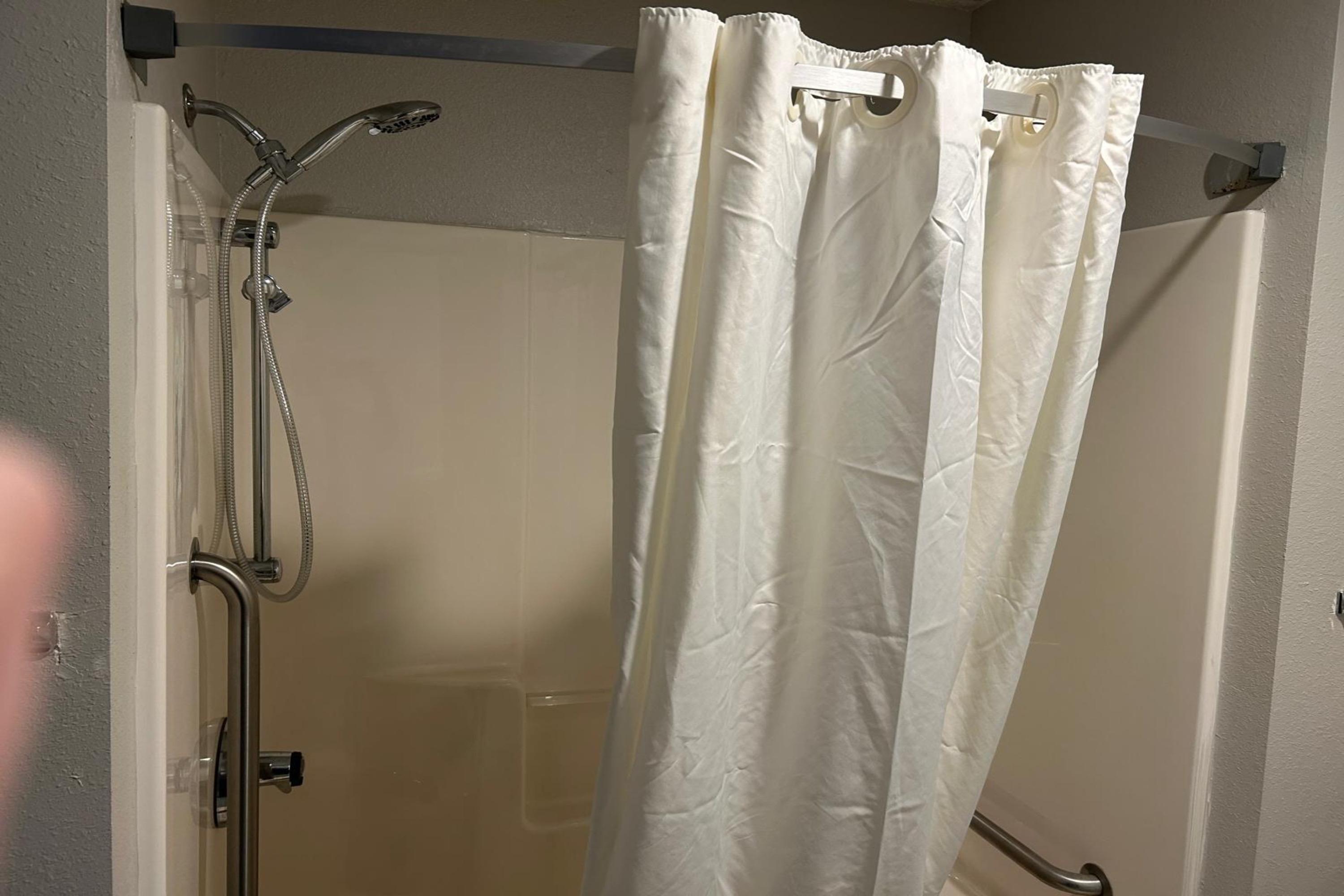 Guest room bath at the AmericInn by Wyndham Saint Ignace in Saint Ignace, Michigan