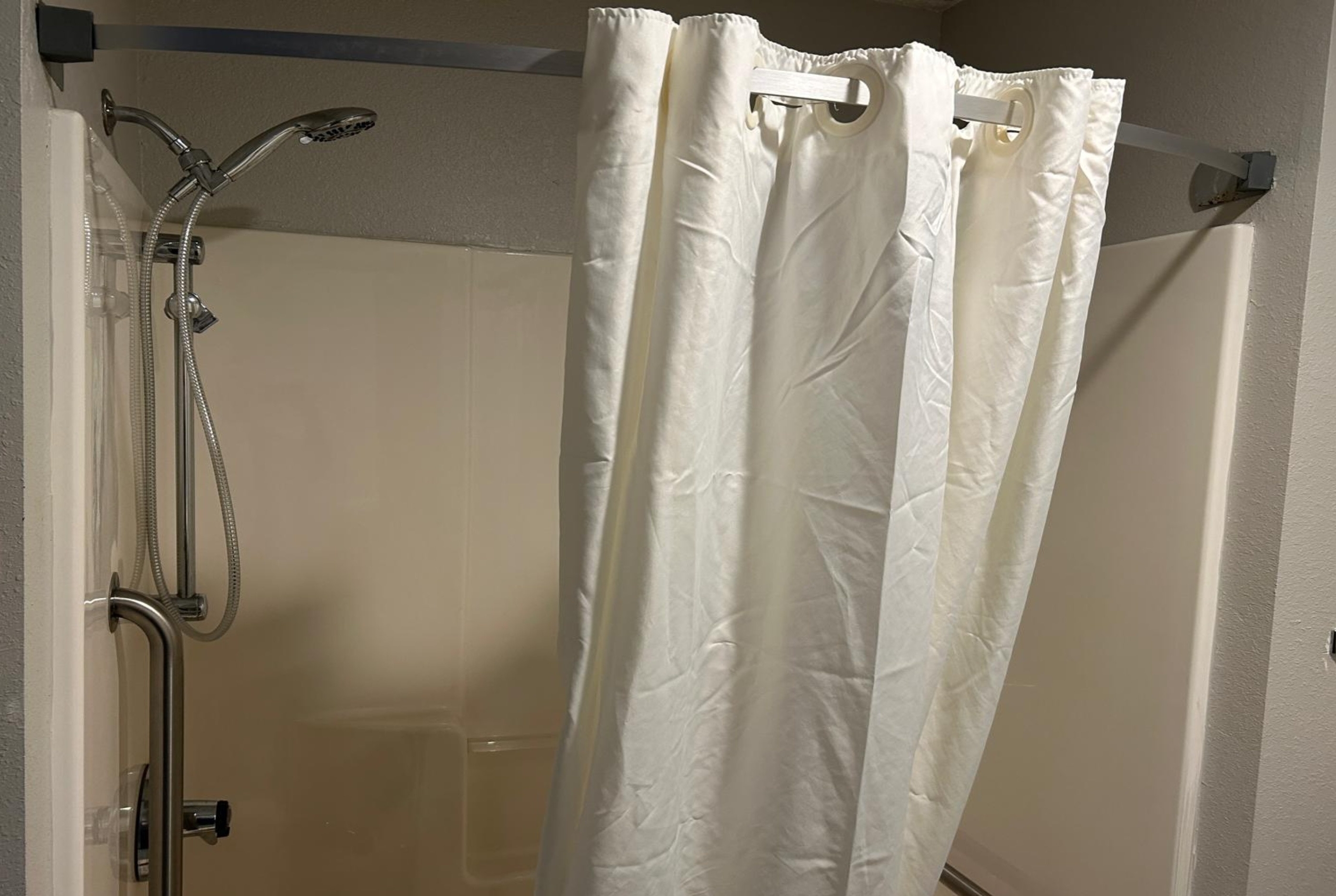 Guest room bath at the AmericInn by Wyndham Saint Ignace in Saint Ignace, Michigan