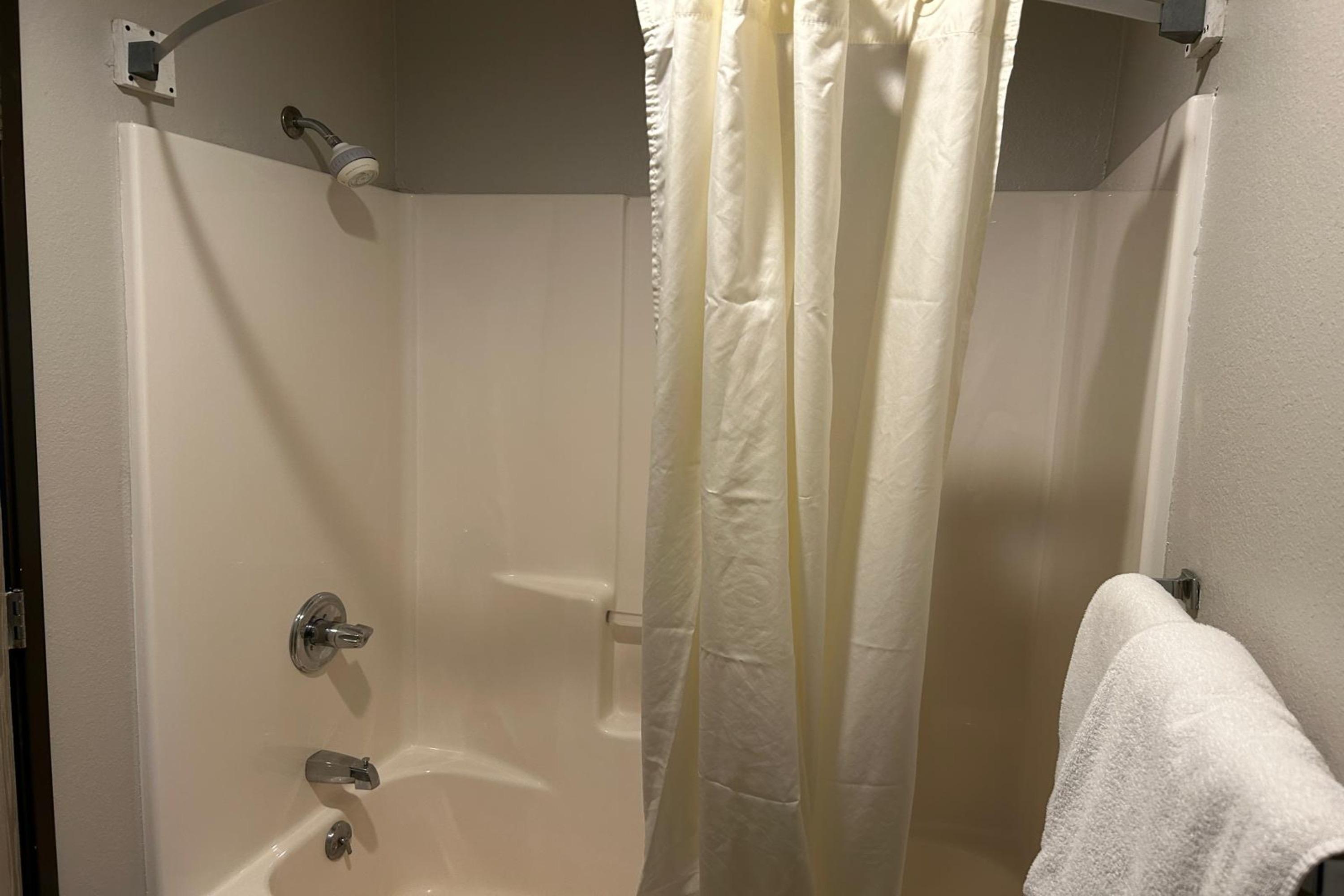 Guest room bath at the AmericInn by Wyndham Saint Ignace in Saint Ignace, Michigan
