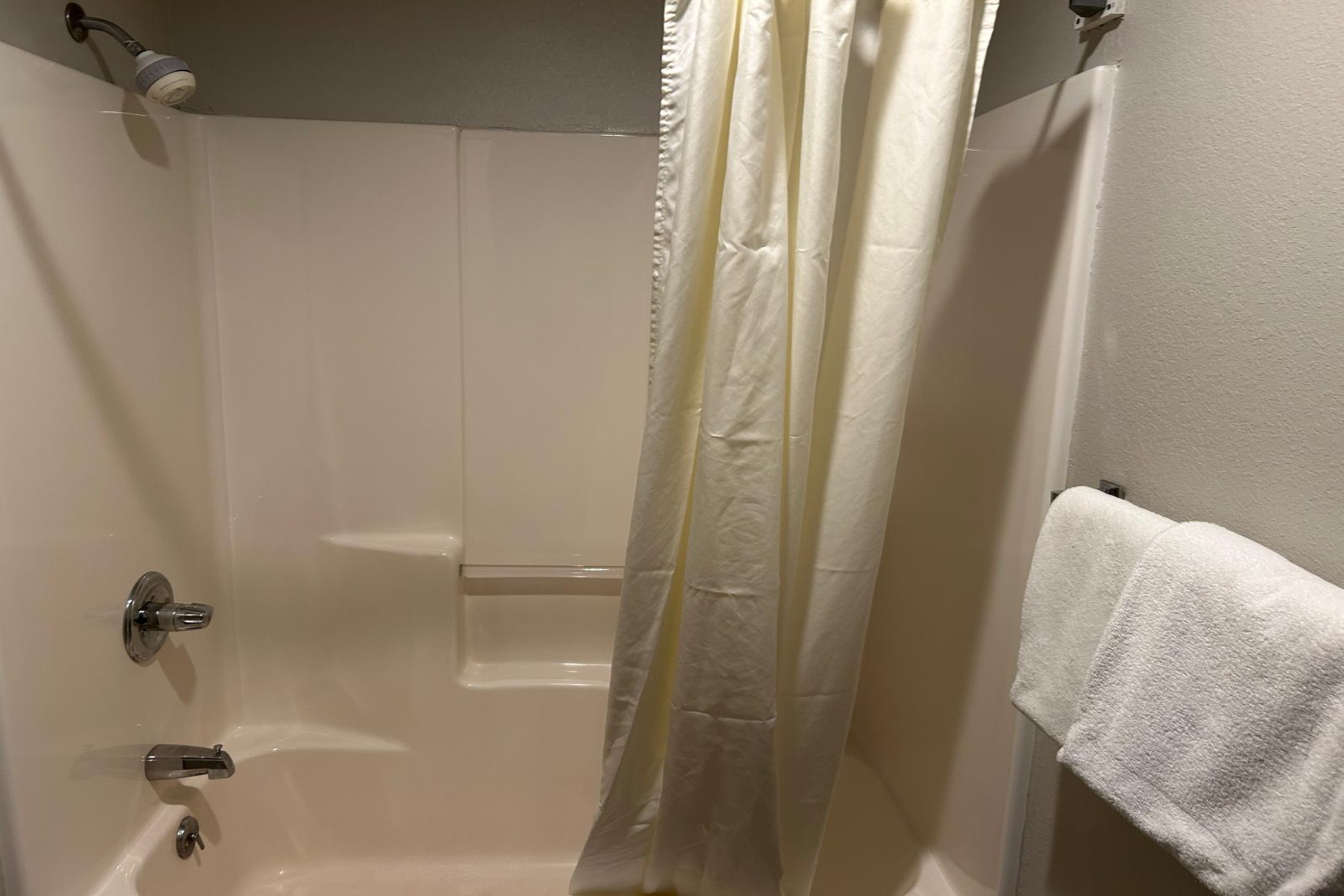 Guest room bath at the AmericInn by Wyndham Saint Ignace in Saint Ignace, Michigan