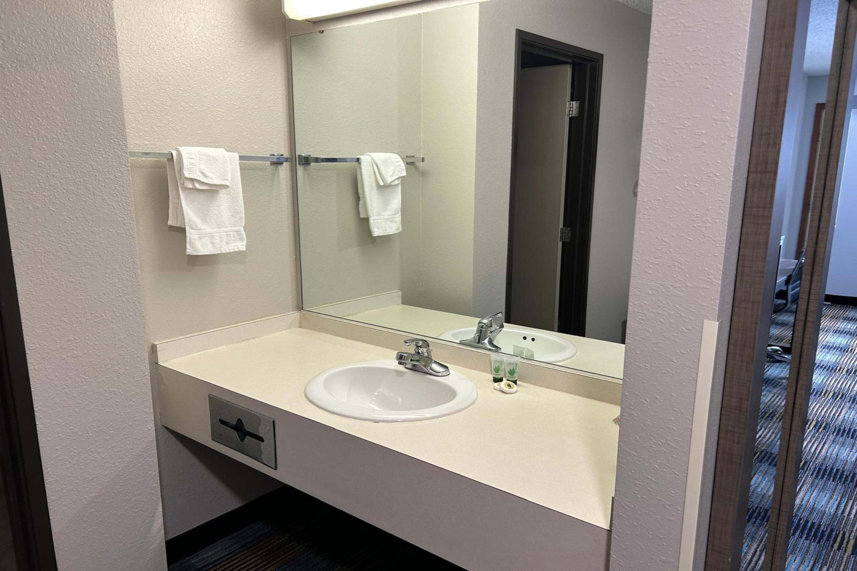 Guest room bath at the AmericInn by Wyndham Saint Ignace in Saint Ignace, Michigan
