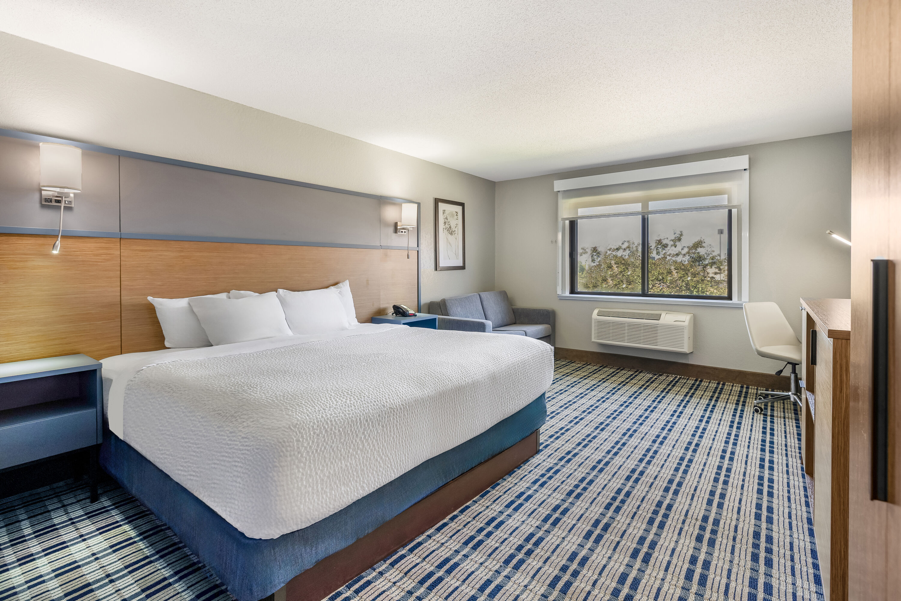 King bed guest room at the AmericInn by Wyndham Albert Lea in Albert Lea, Minnesota
