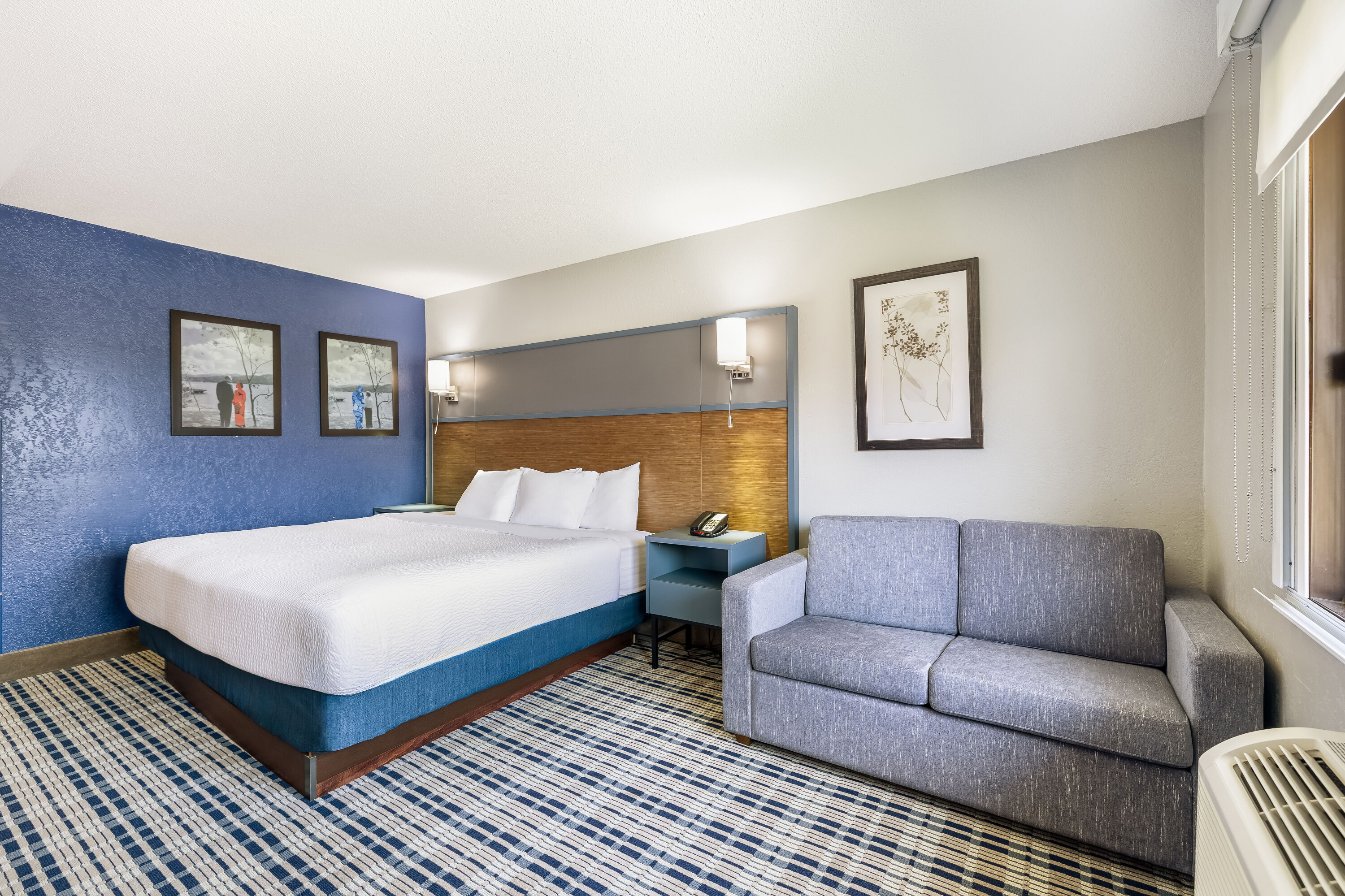King bed guest room at the AmericInn by Wyndham Albert Lea in Albert Lea, Minnesota