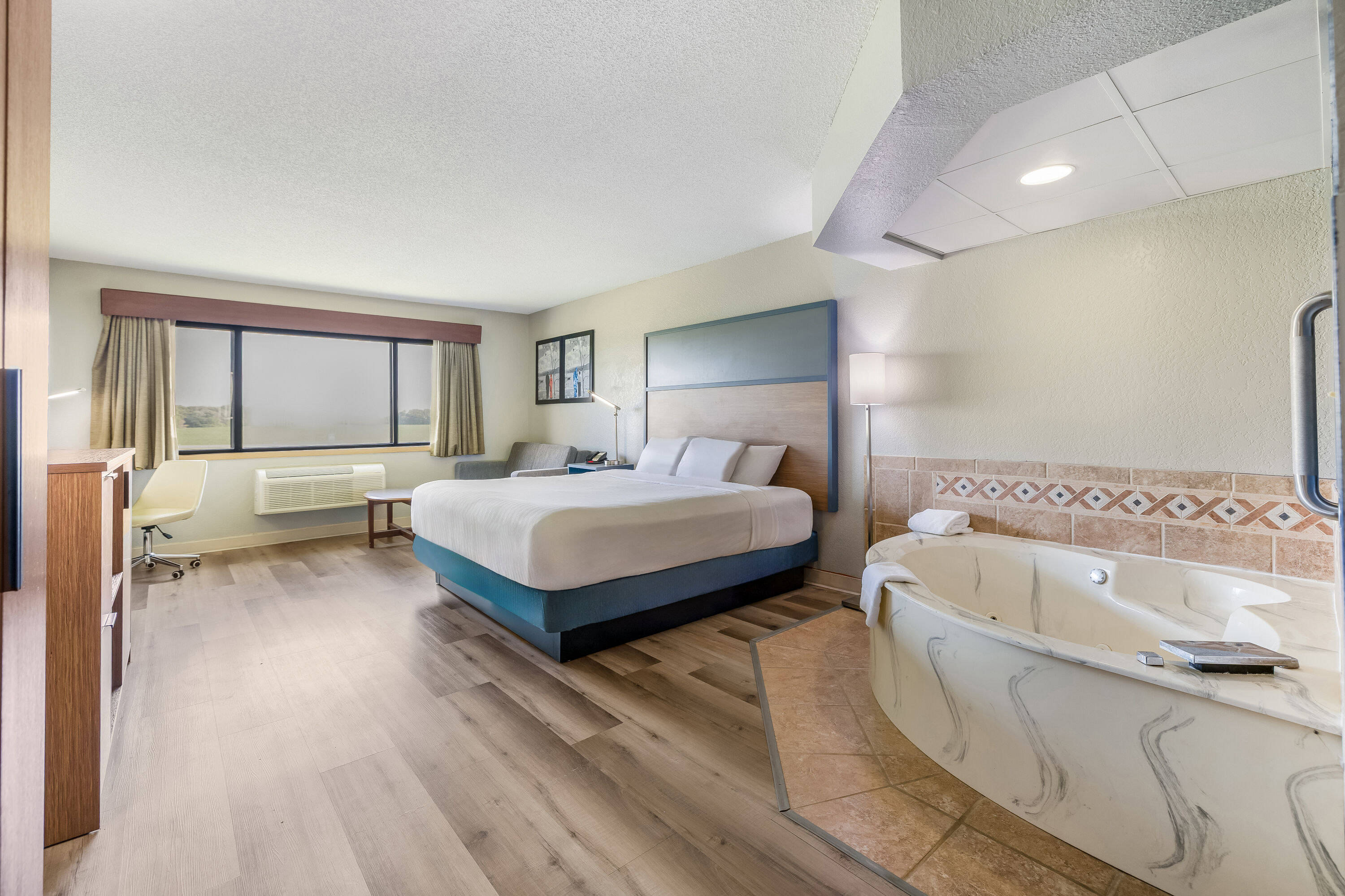 King bed guest room at the AmericInn by Wyndham Albert Lea in Albert Lea, Minnesota