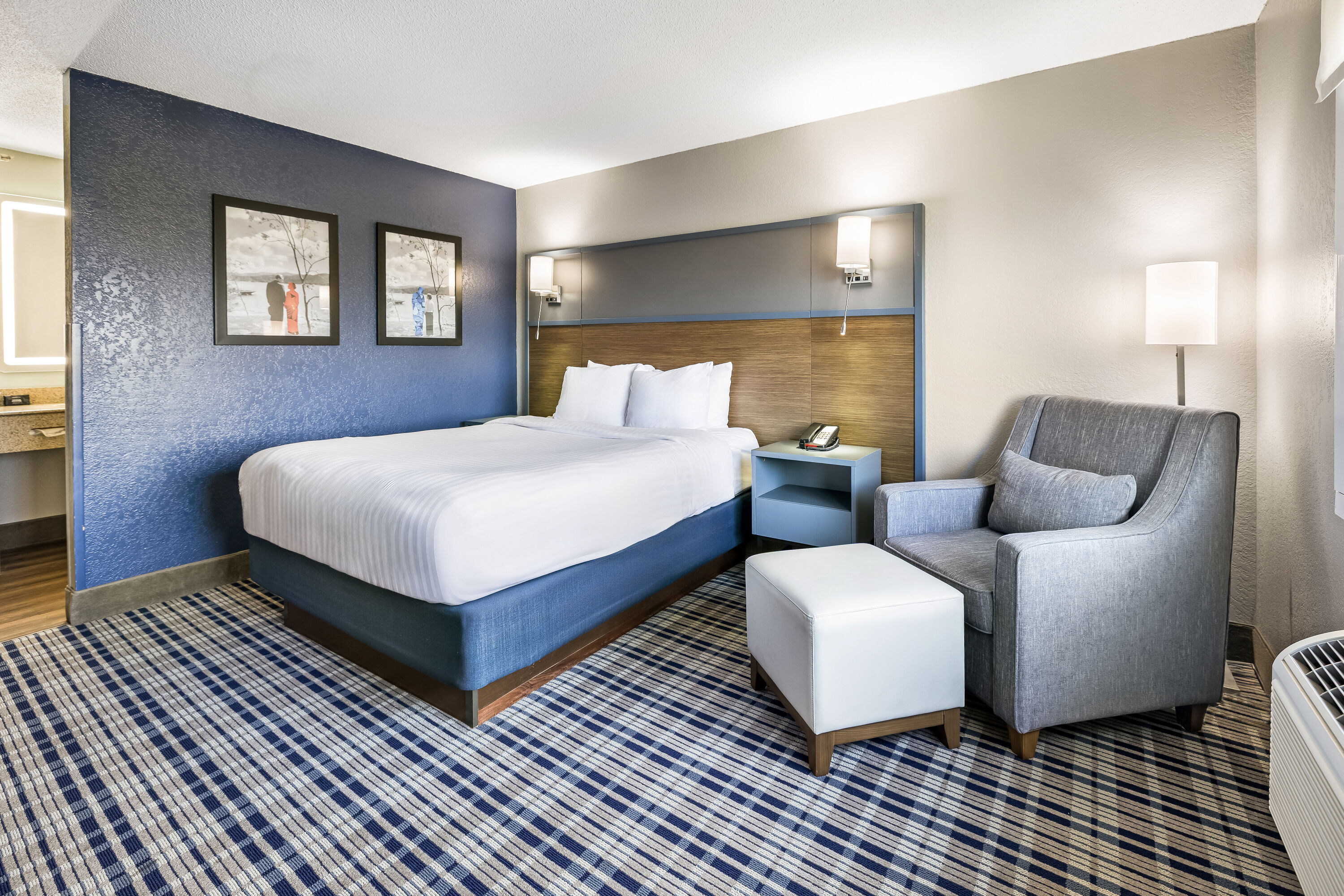 Queen bed guest room at the AmericInn by Wyndham Albert Lea in Albert Lea, Minnesota