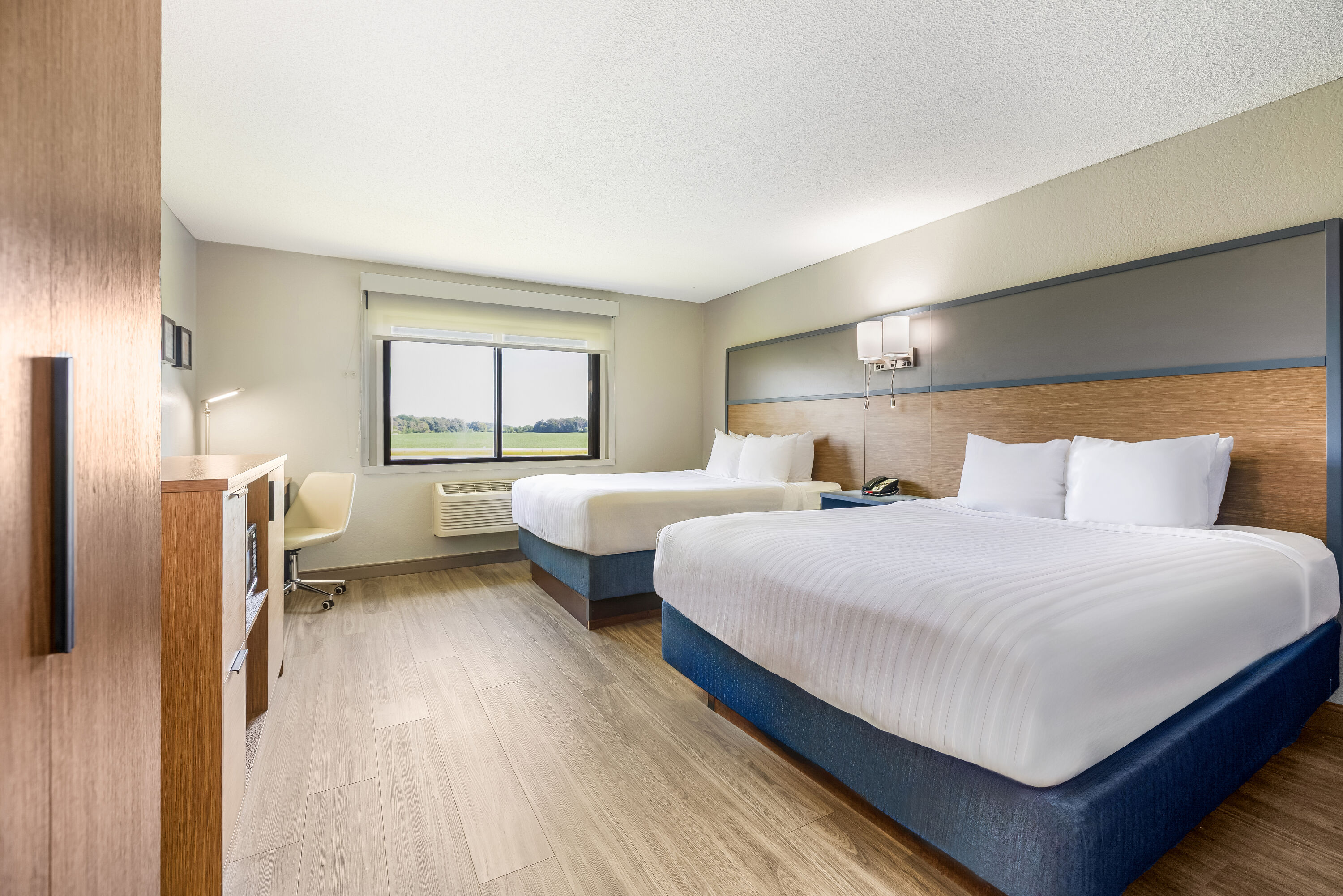 Queen bed guest room at the AmericInn by Wyndham Albert Lea in Albert Lea, Minnesota