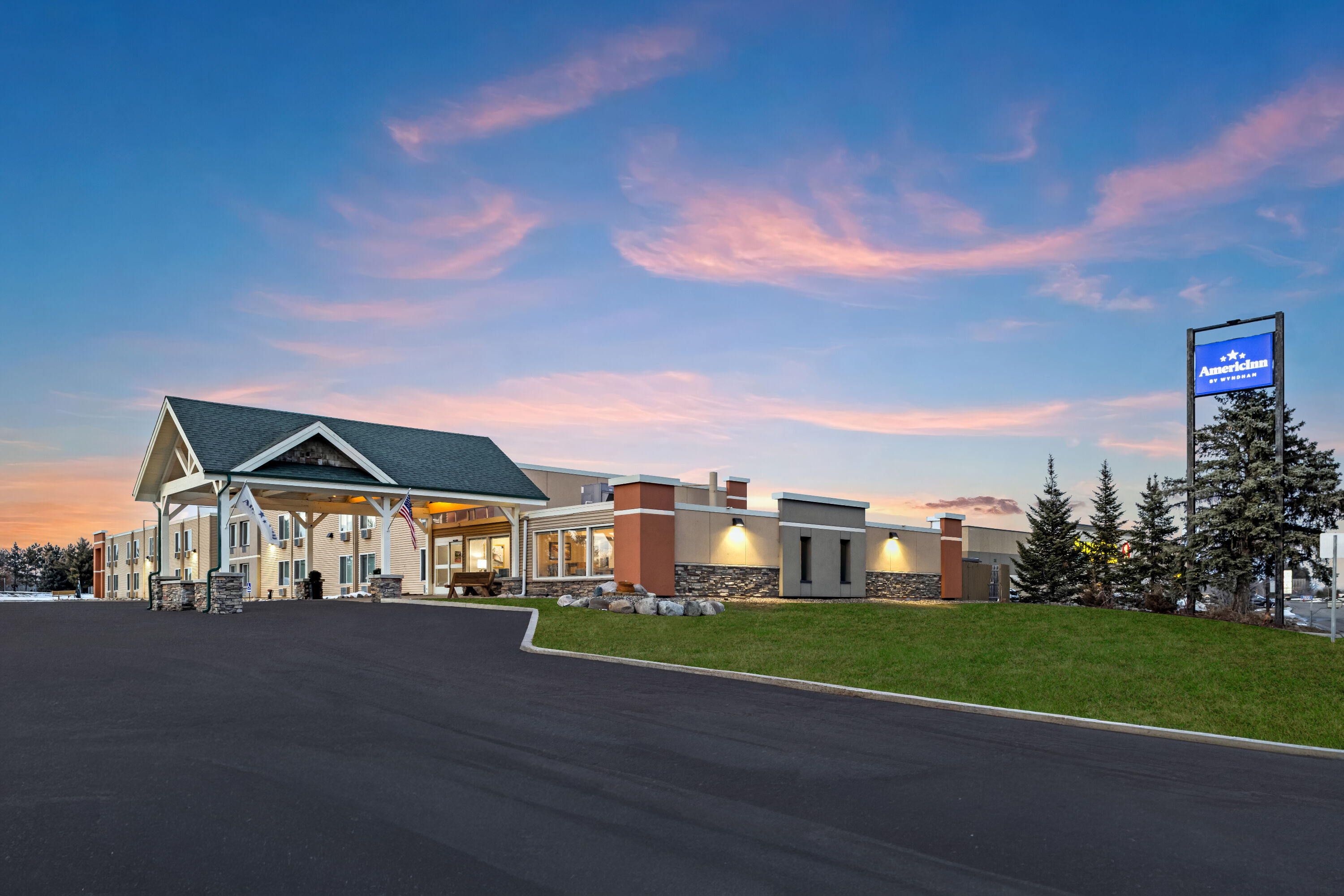 Exterior Dusk Image of AmericInn by Wyndham Baxter Brainerd hotel in Baxter, Minnesota