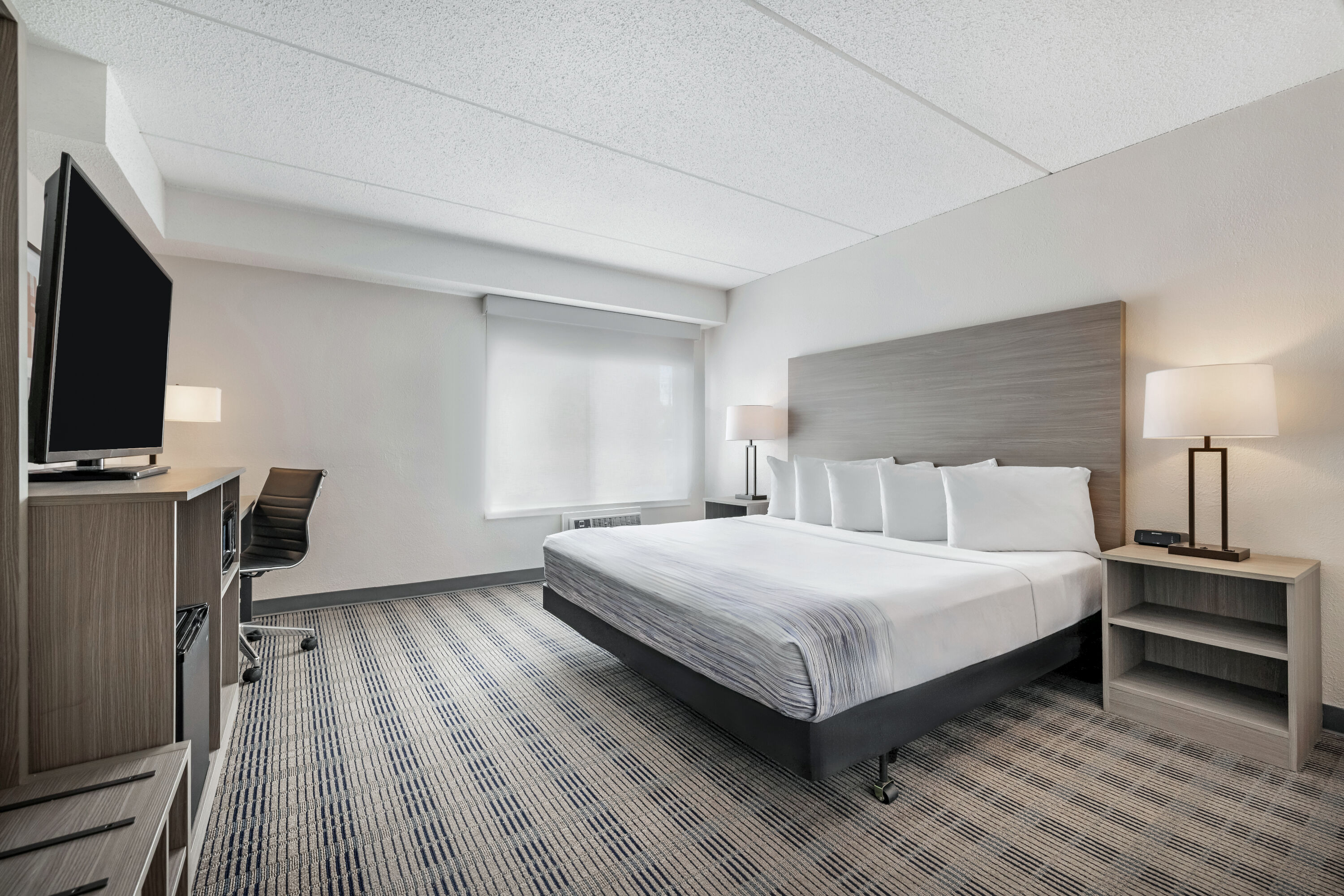 King bed guest room at the AmericInn by Wyndham Baxter Brainerd in Baxter, Minnesota