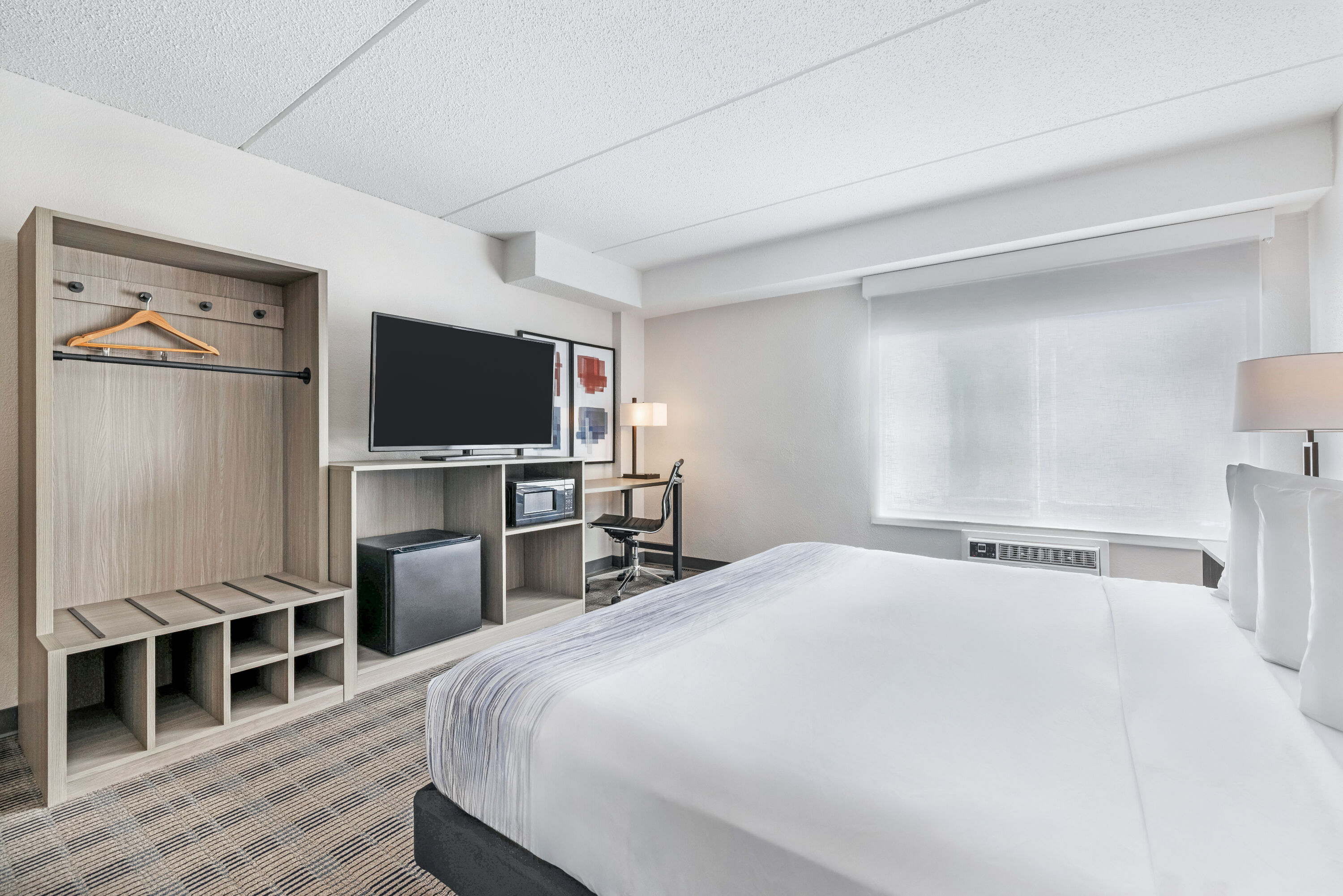 King bed guest room at the AmericInn by Wyndham Baxter Brainerd in Baxter, Minnesota