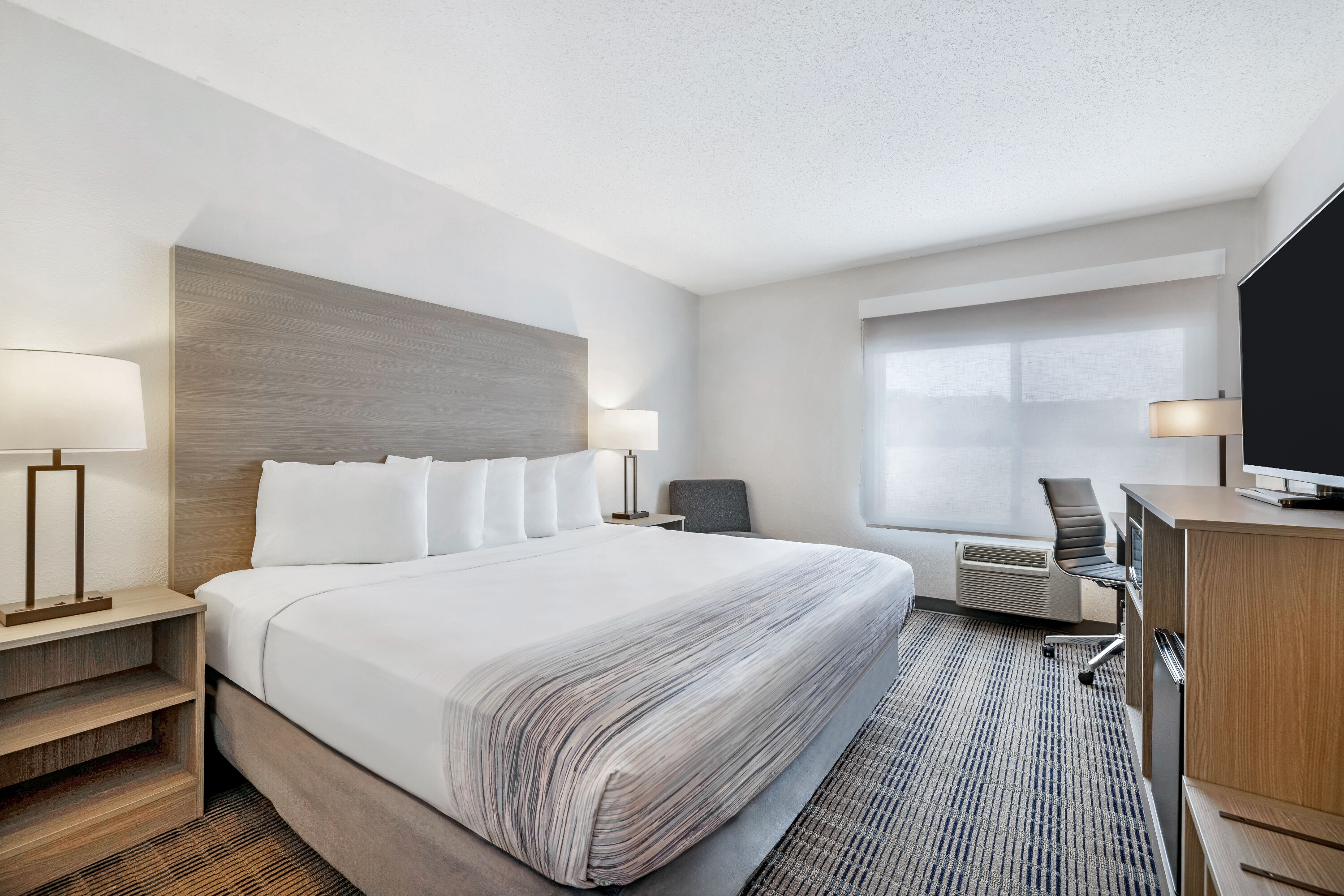 King bed guest room at the AmericInn by Wyndham Baxter Brainerd in Baxter, Minnesota